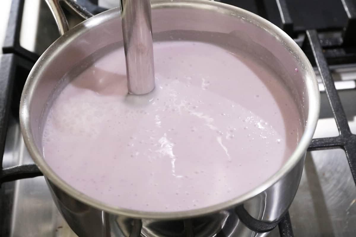 using an emersion blender to mix the batter in a pot