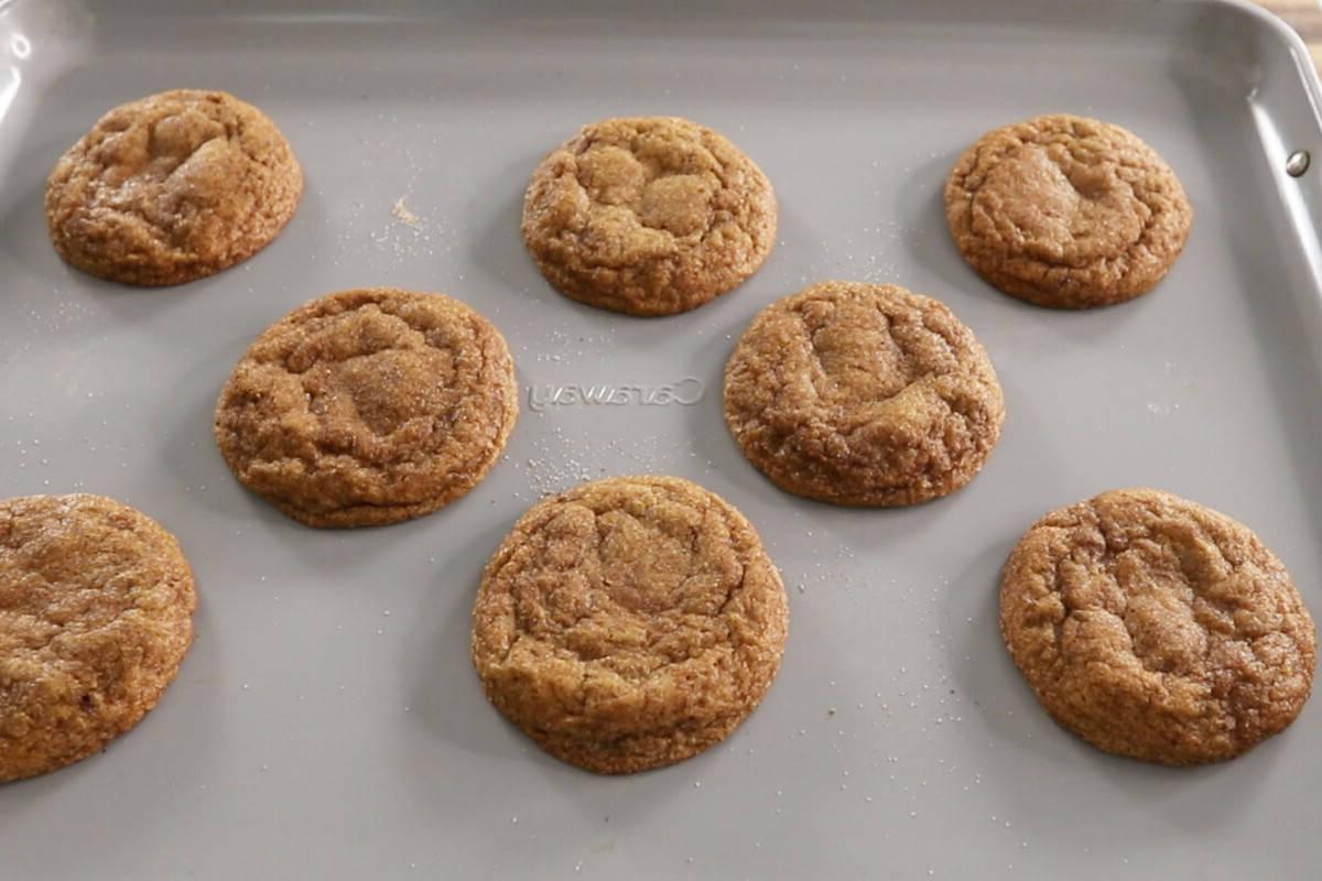 freshly baked vegan pumpkin sugar cookies on baking sheet