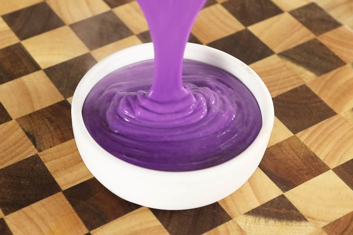 pouring the creme brulee batter into a white container