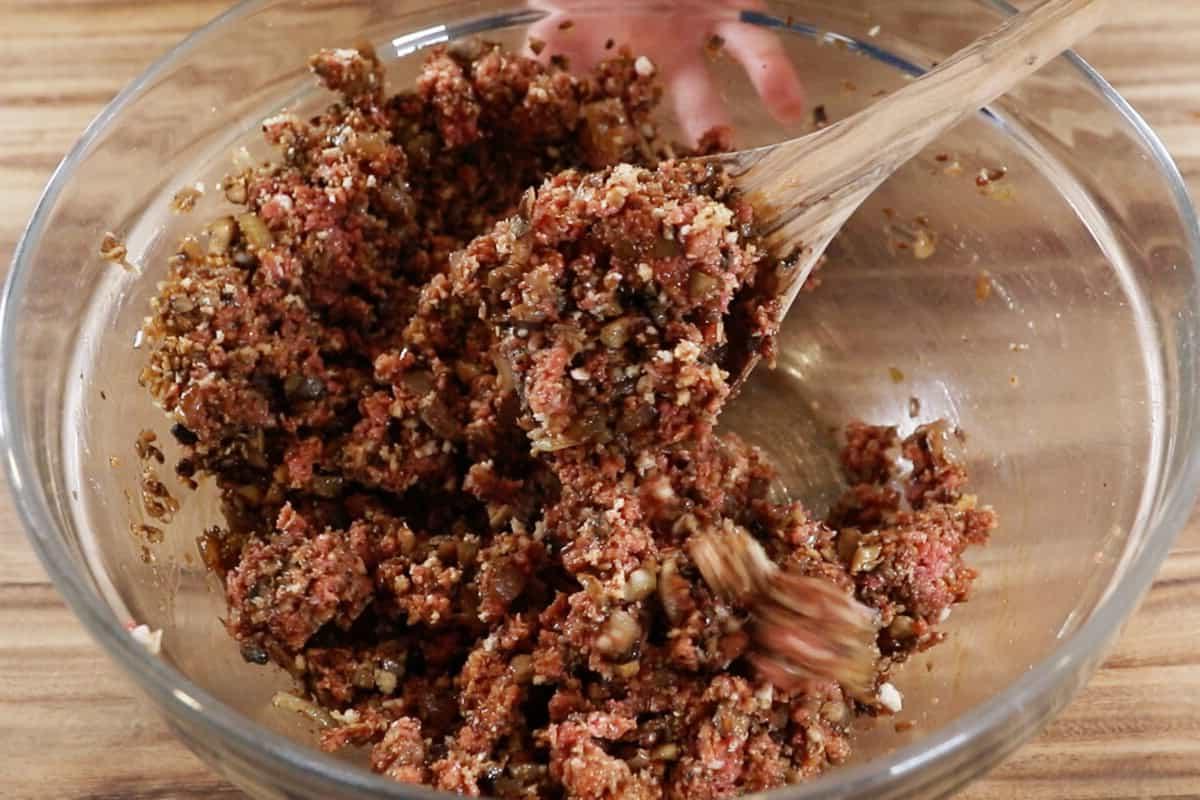 Ανάμειξη της γέμισης της μπριζόλας burger σε μπολ