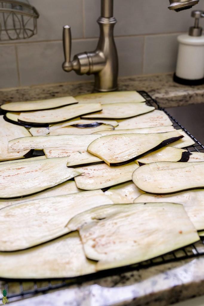 sweating raw eggplant lightly salted laying out over the sink