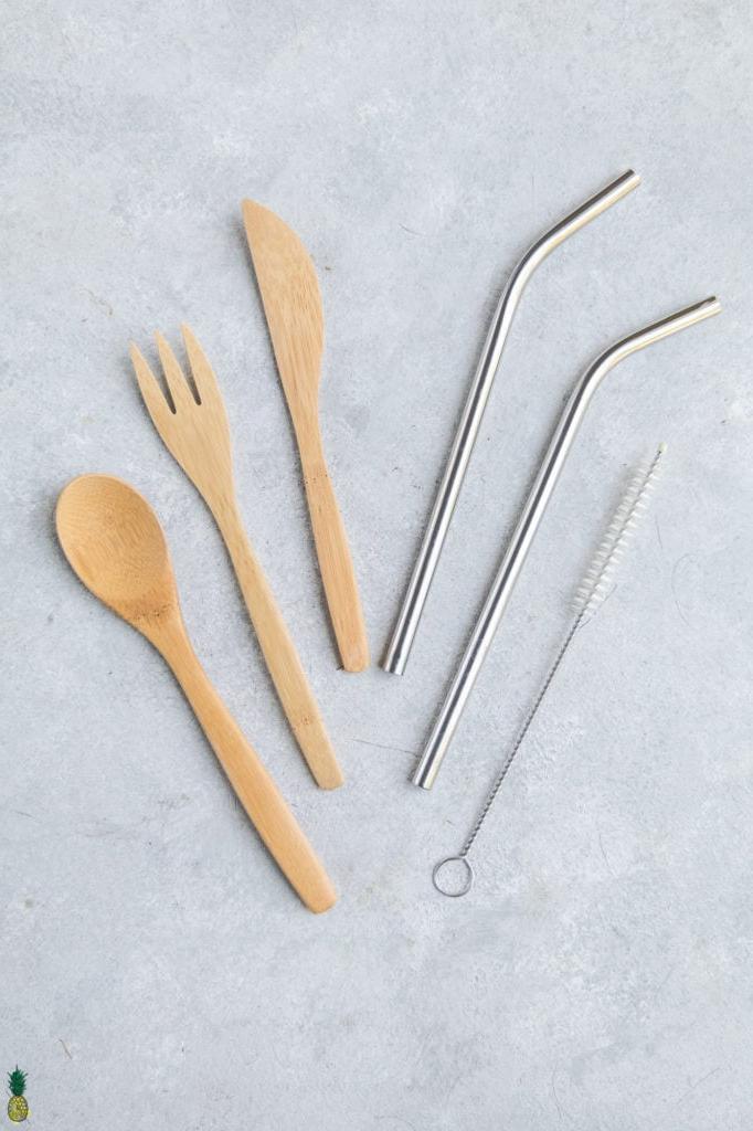 overhead photo of reusable straws and utensils