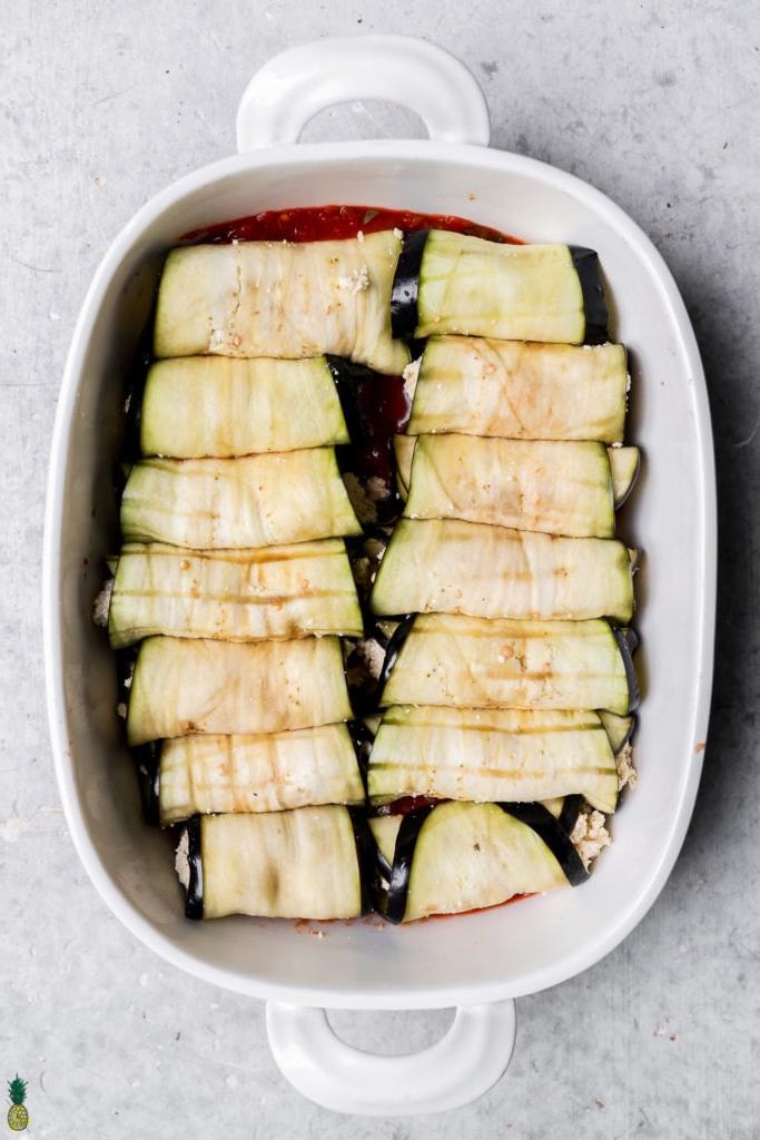 Step by step overhead image of eggplant rollatini in a baking dish with no cheese or sauce