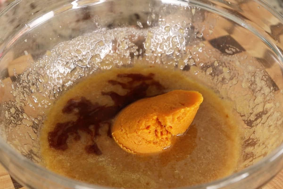 preparing vegan pumpkin sugar cookies in glass bowl