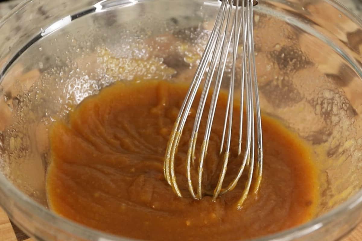 preparing vegan pumpkin sugar cookies in glass bowl