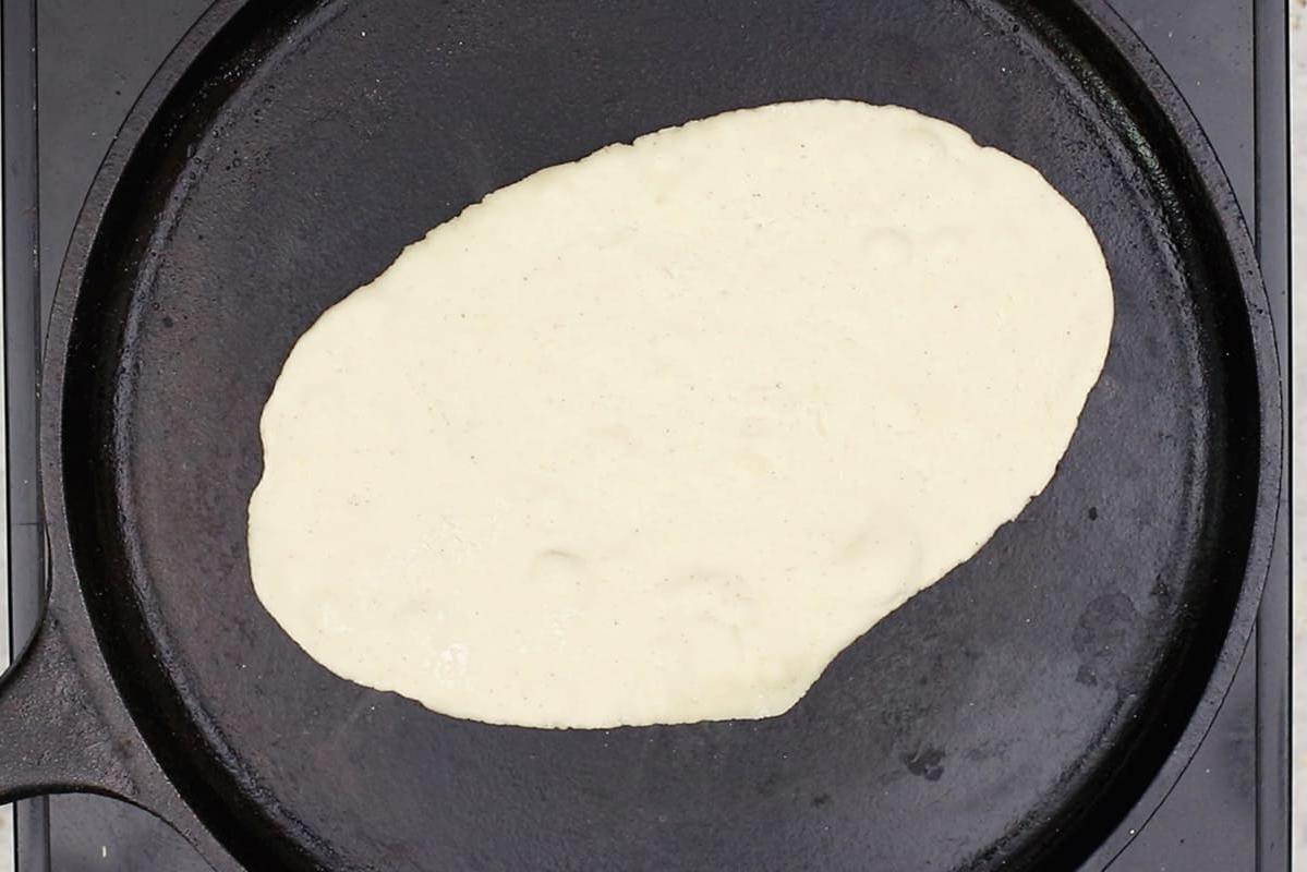 cooking gluten-free flatbread on cast iron griddle