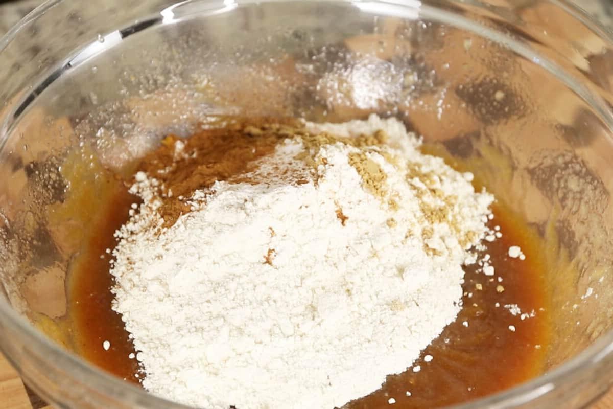 preparing vegan pumpkin sugar cookies in glass bowl