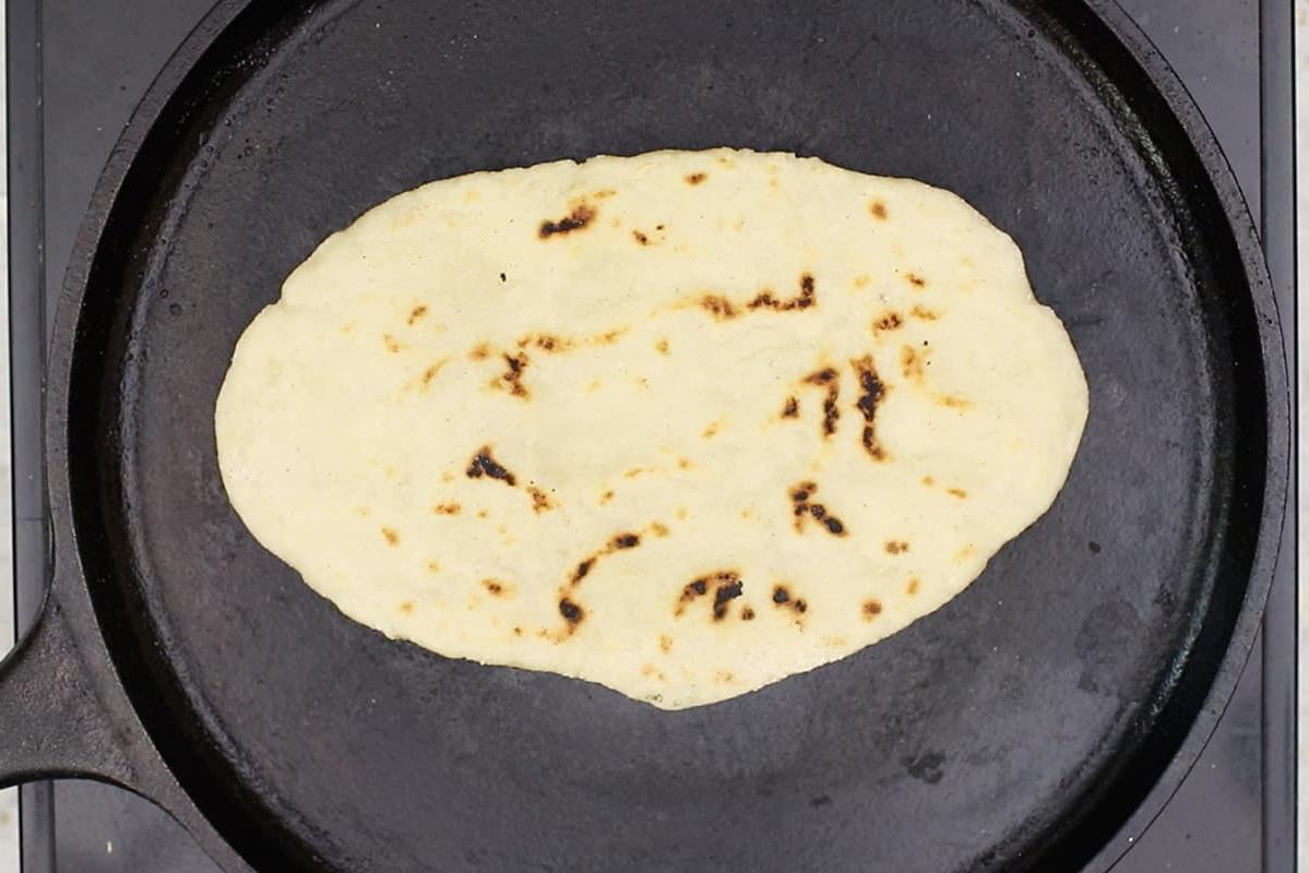 cooking gluten-free flatbread on cast iron griddle