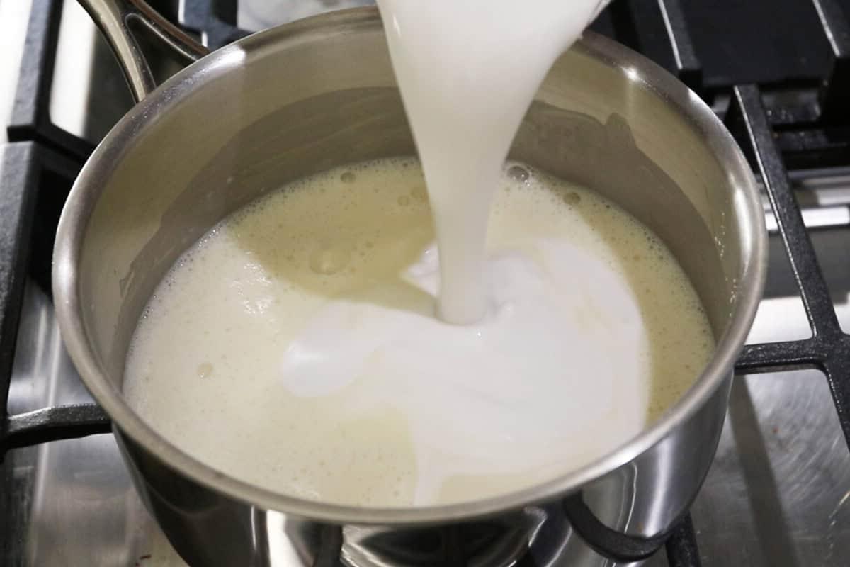 step by step - pouring milk into a pot on the stove
