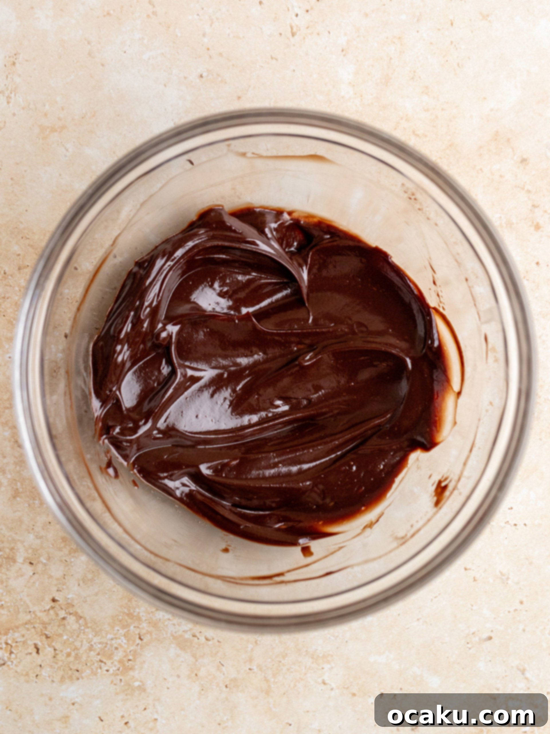 Close-up of mascarpone cream ingredients being mixed in a bowl with an electric mixer.