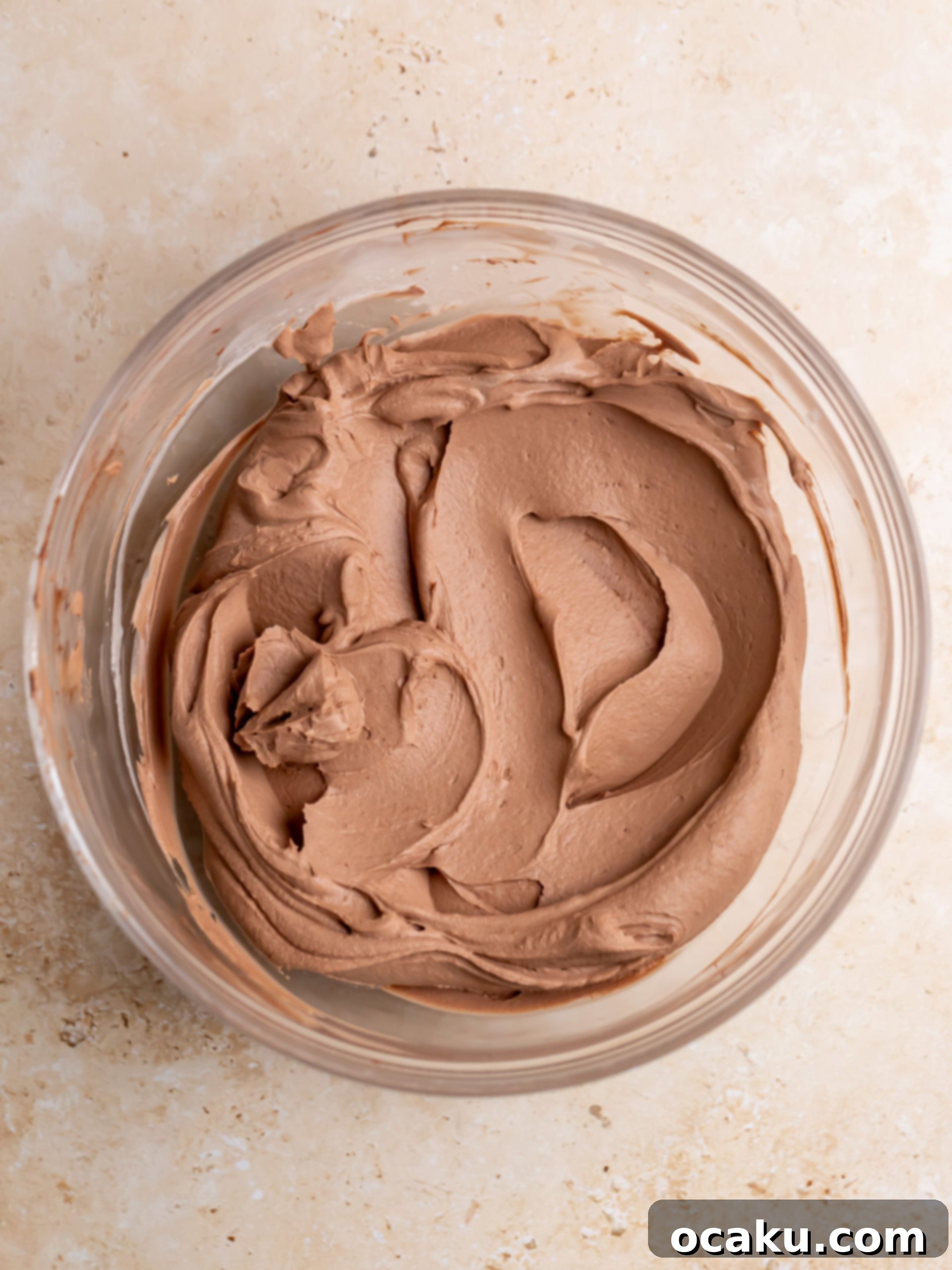 The final chocolate mascarpone cream being mixed and scraped down from the bowl.