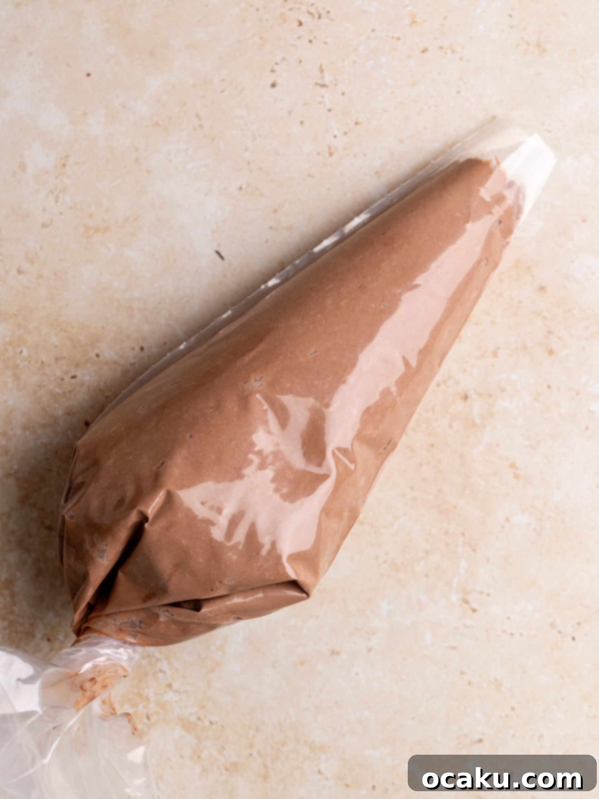 A freshly dusted chocolate tiramisu cup with cocoa powder on top.