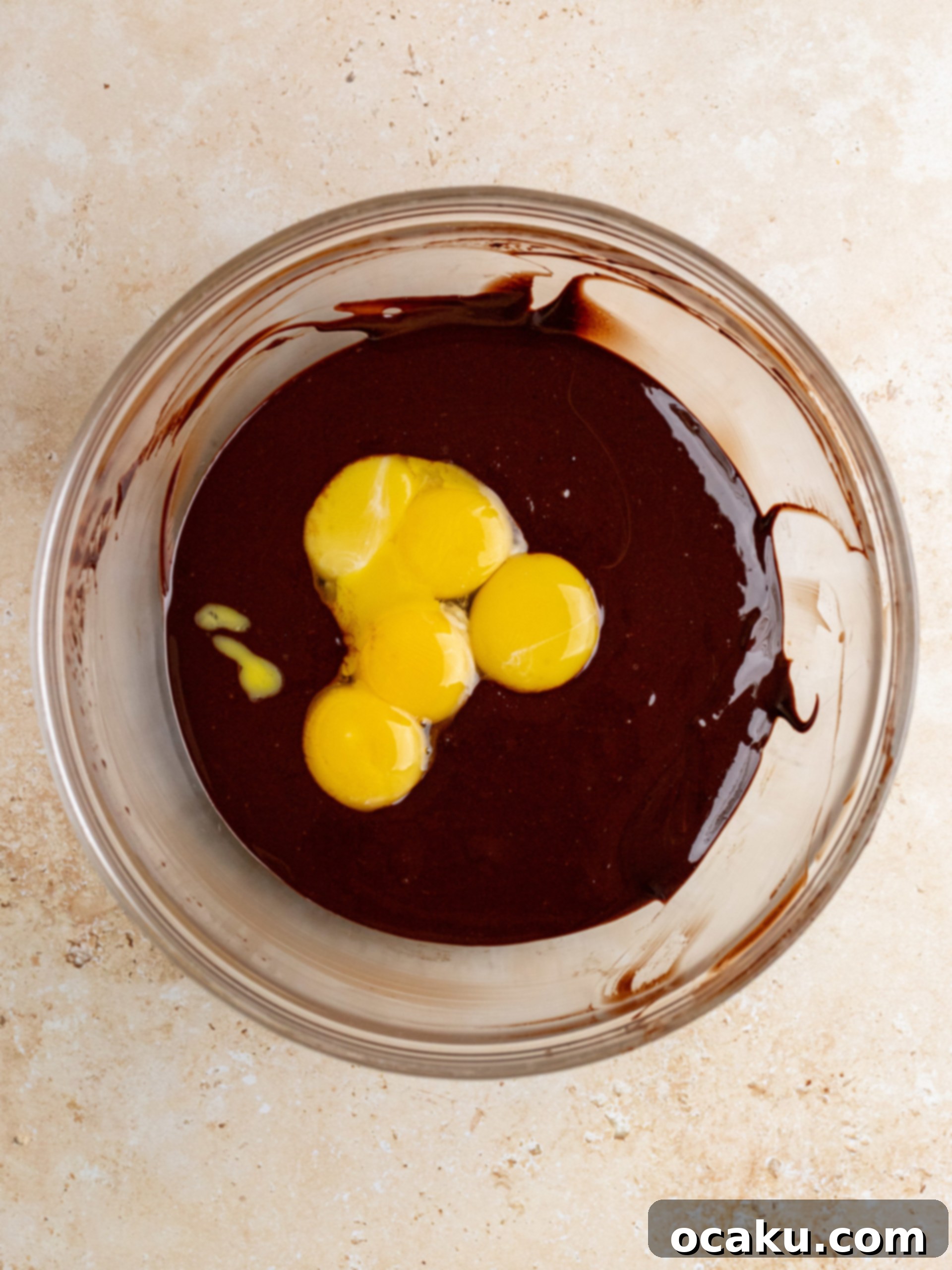 Egg whites being whisked into a frothy meringue in a stand mixer.