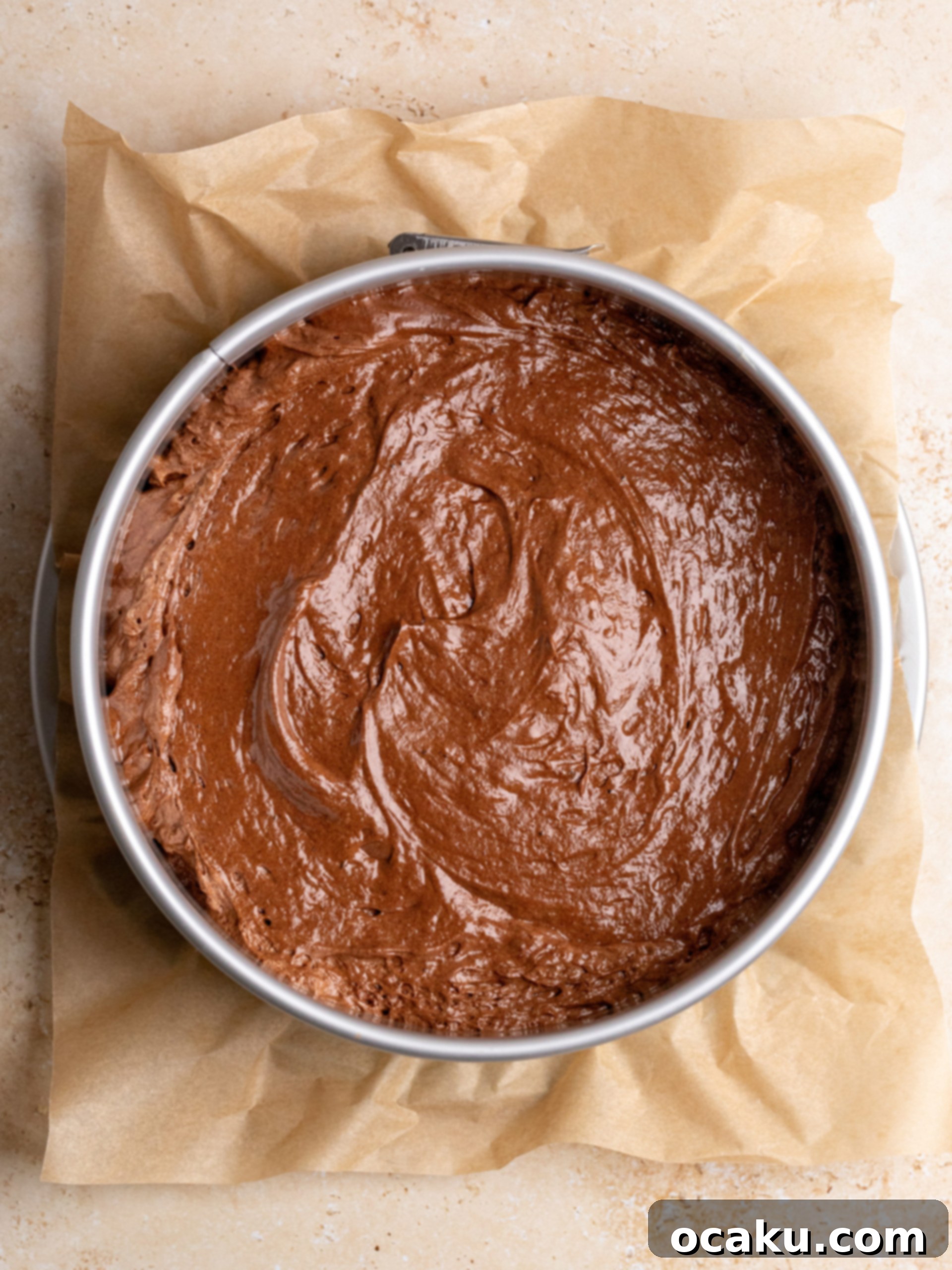 More meringue being folded into the chocolate espresso cake batter.