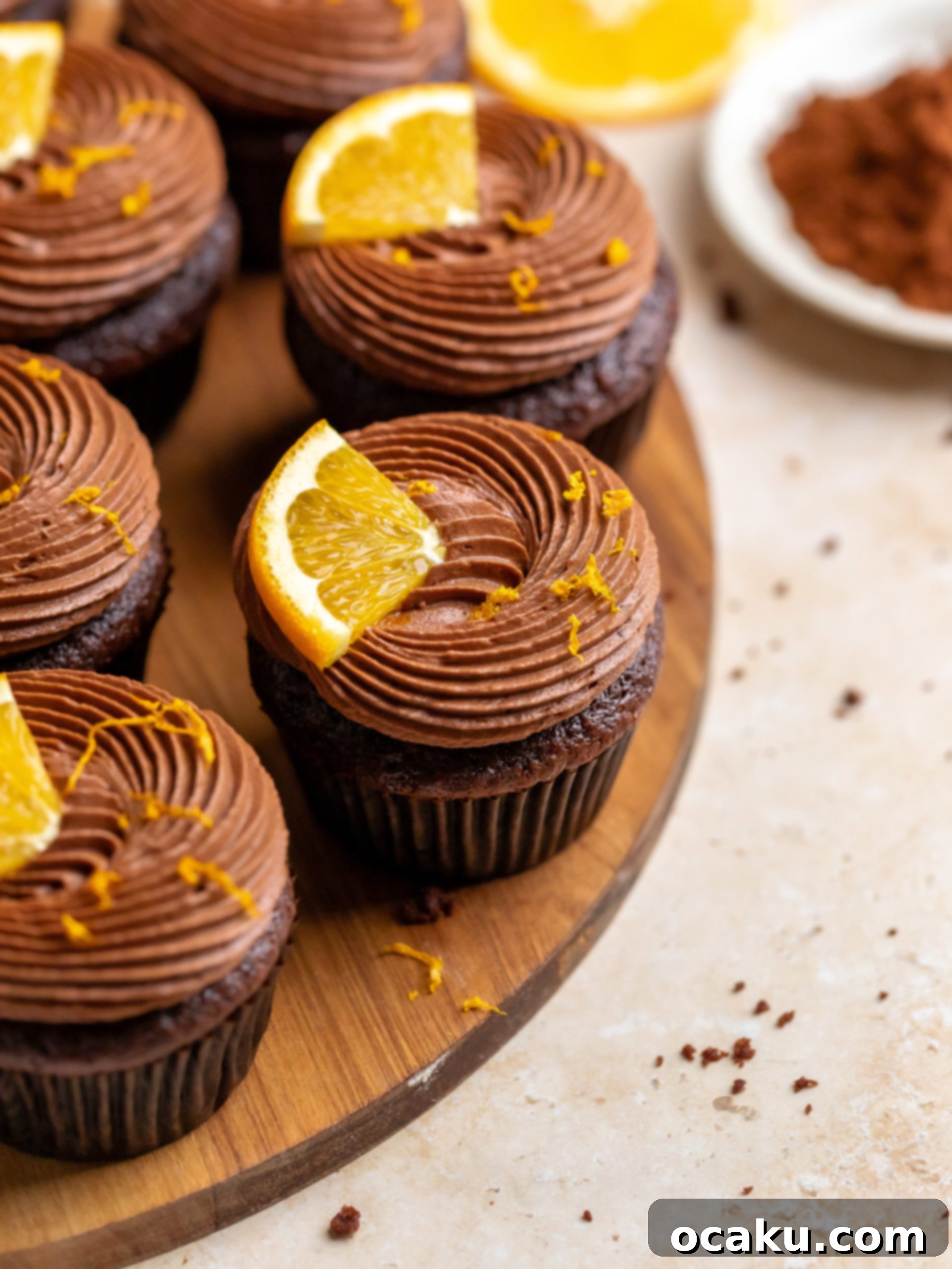 Close-up of baked chocolate orange cupcakes, cooling in a cupcake pan.