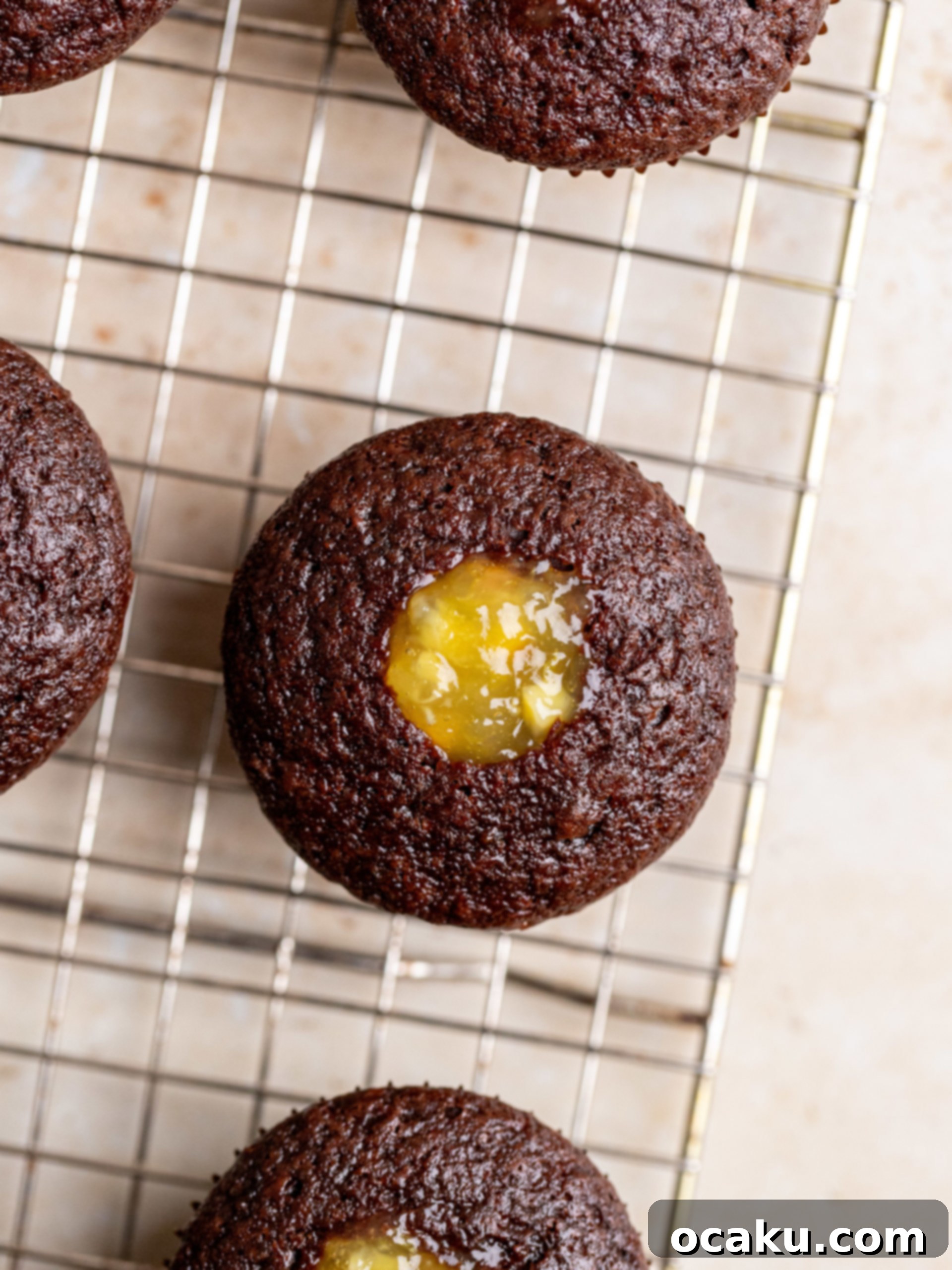 A close-up of a single chocolate orange cupcake decorated with an orange slice.