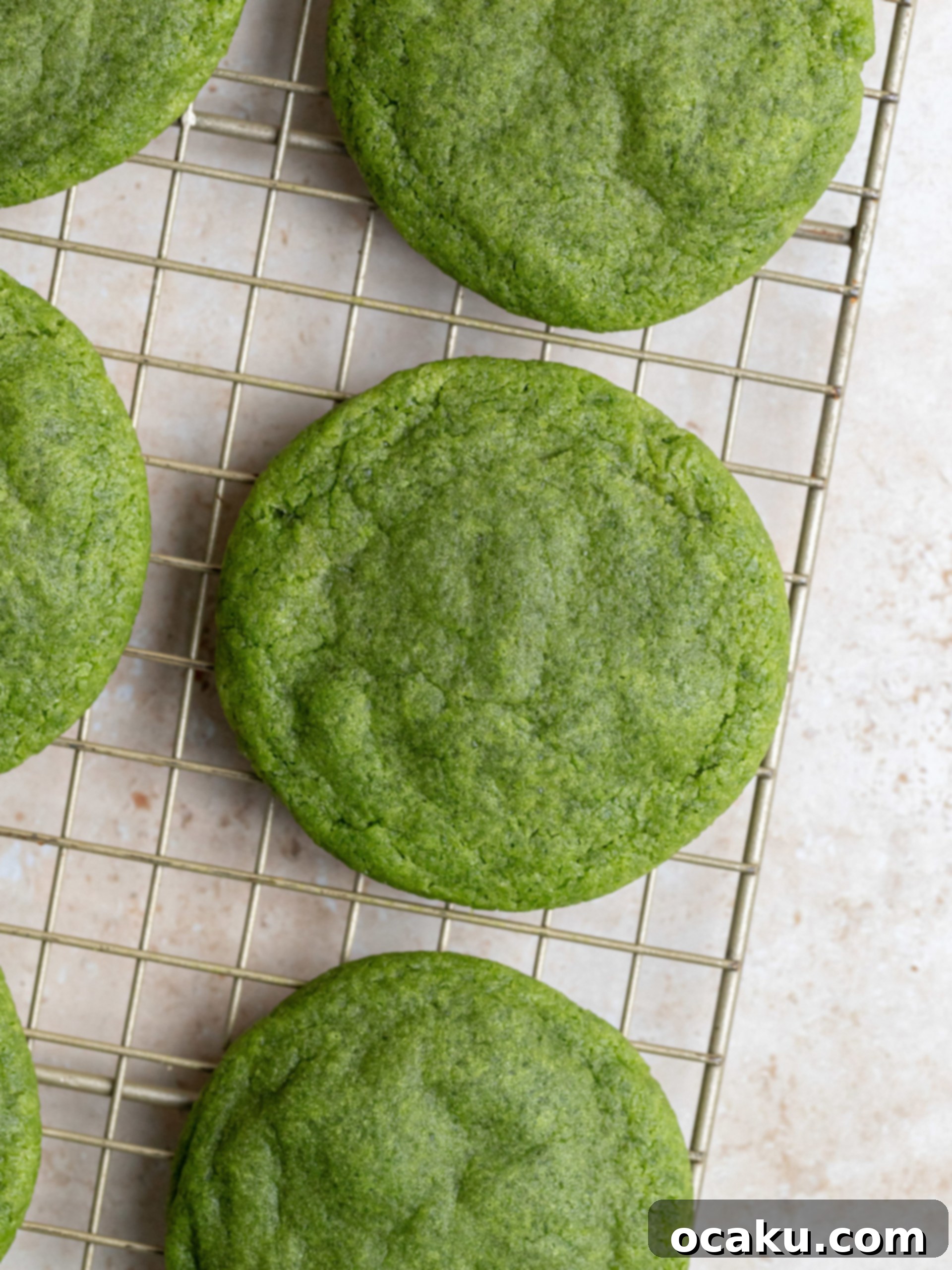 Creamy Matcha Latte Cookies 5 Mascarpone cream being piped onto a matcha cookie in a swirl pattern.
