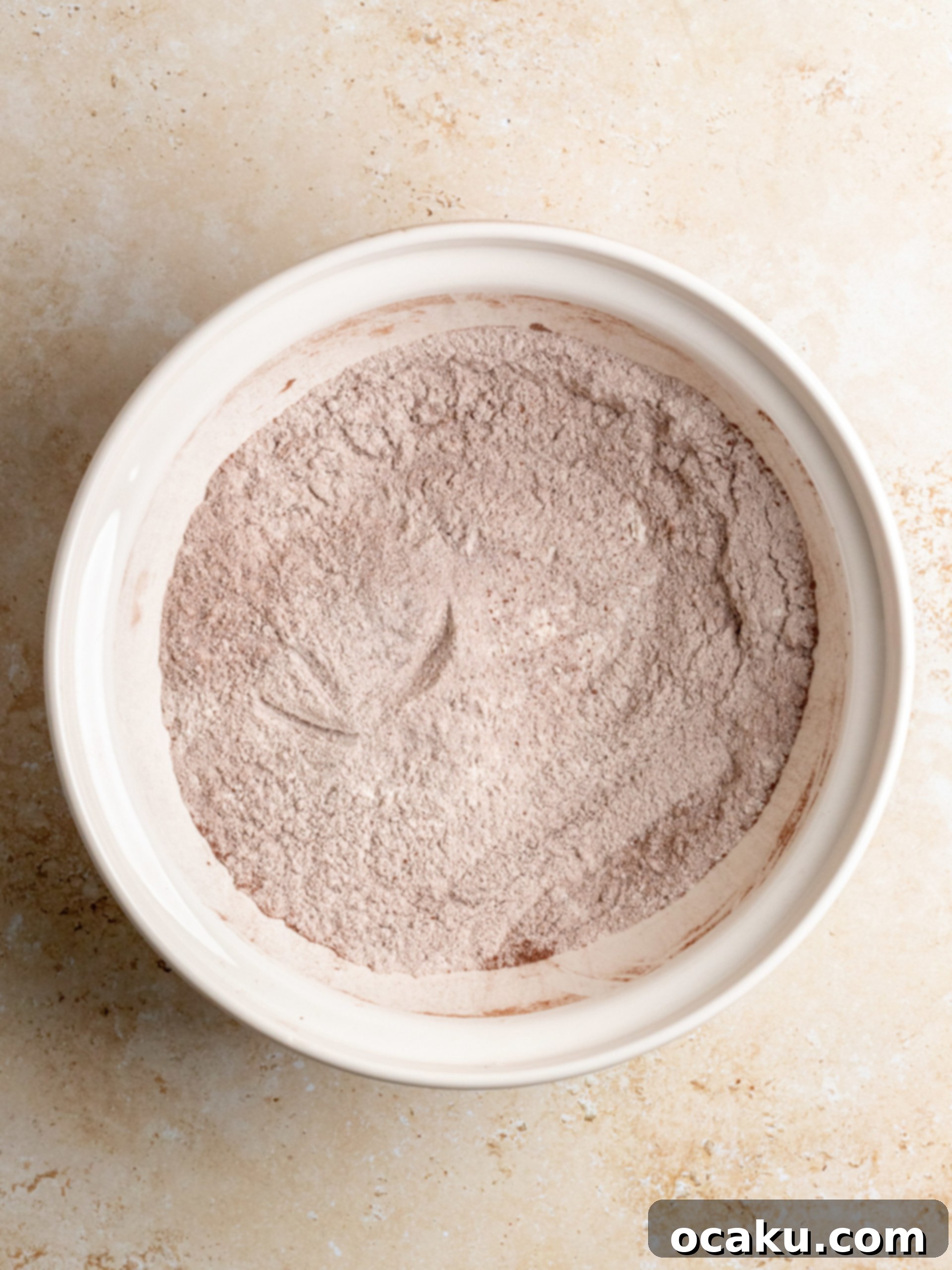 The Ultimate Red Velvet Cake 3 Step-by-step image of mixing wet ingredients for Red Velvet Cake.