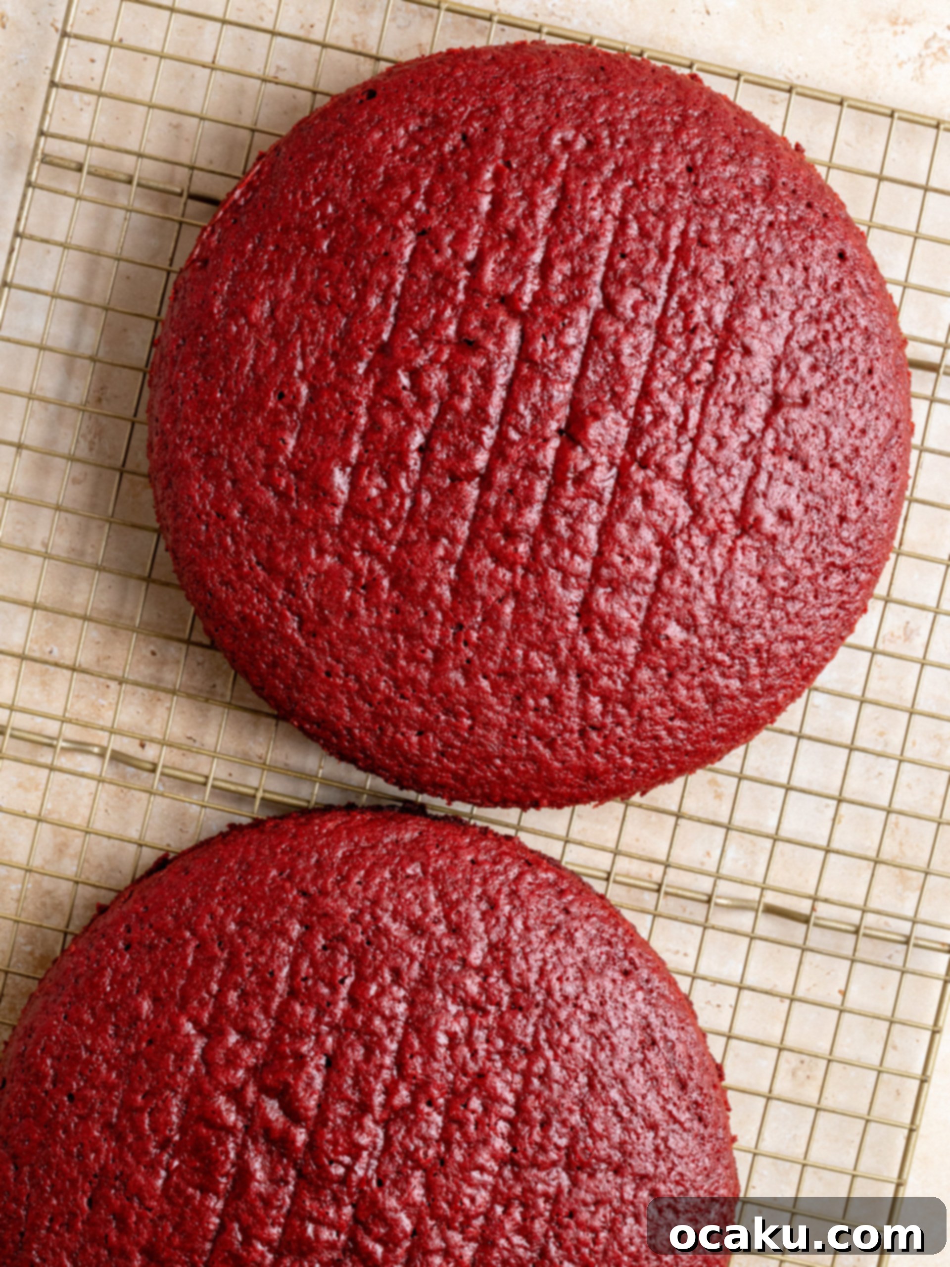 The Ultimate Red Velvet Cake 6 Step-by-step image of baked Red Velvet Cake layers cooling on a rack.