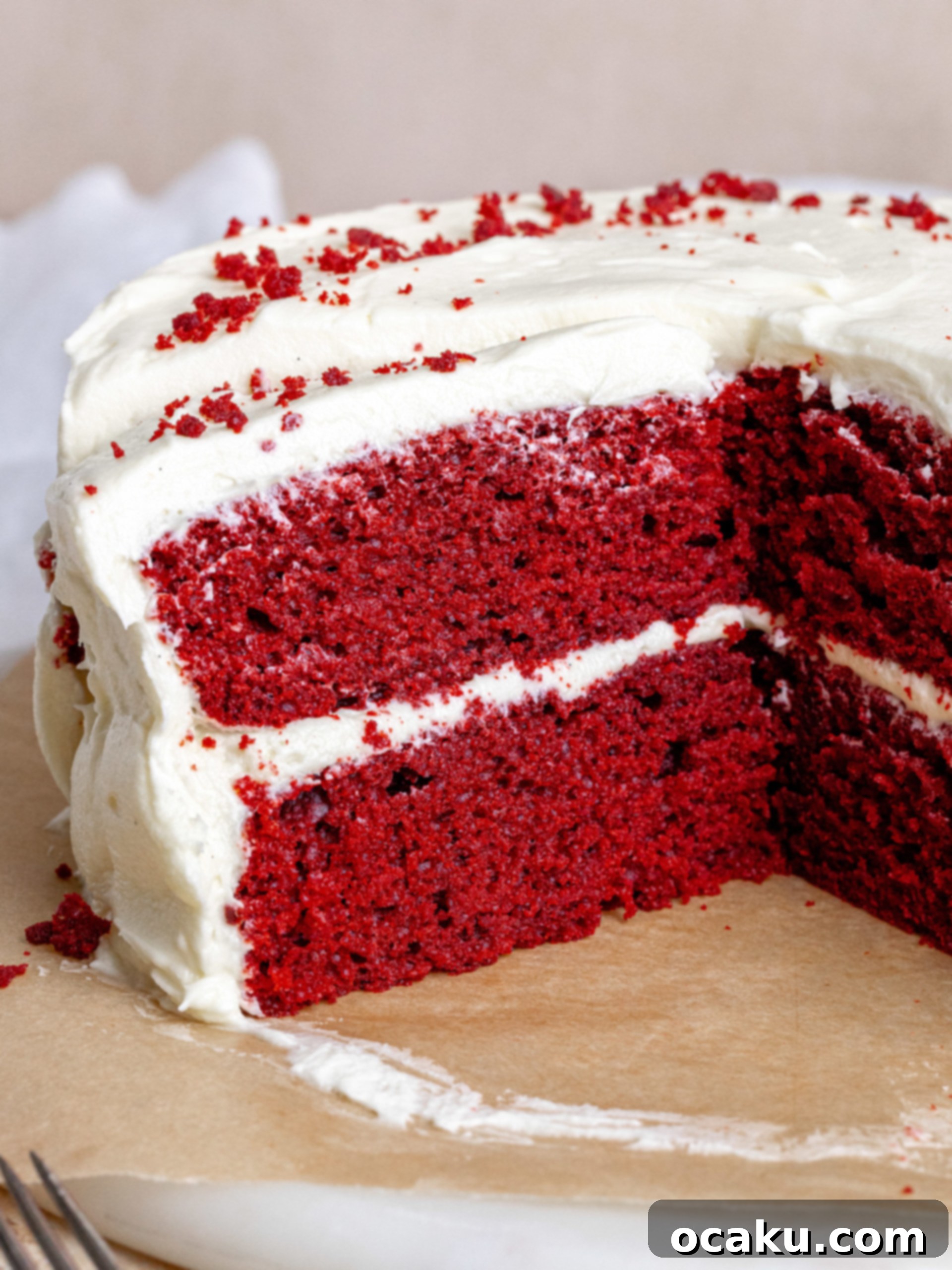 The Ultimate Red Velvet Cake 7 A slice of Red Velvet Cake with a fork, showing its soft texture.