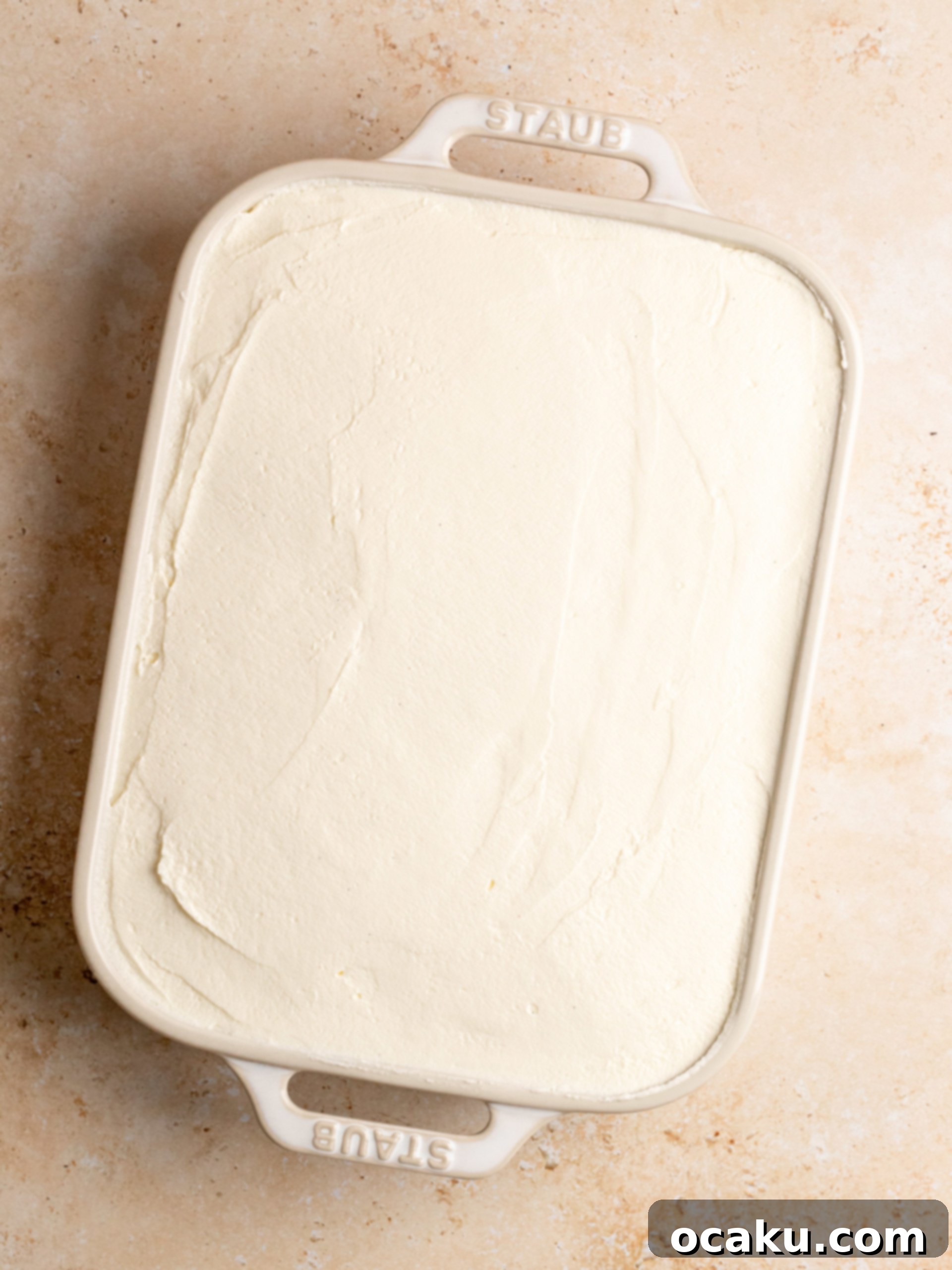 Raspberry Dream Tiramisu 10 Spreading a layer of homemade raspberry jam over the mascarpone cream in the Tiramisu dish.