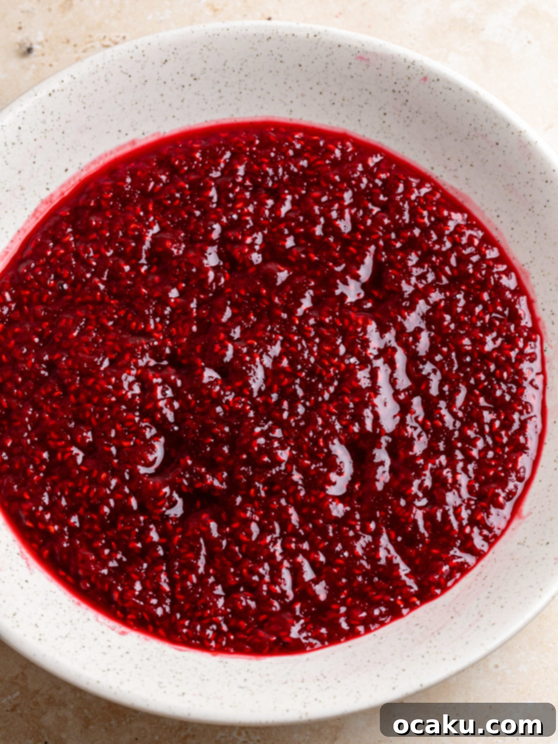 Raspberry Dream Tiramisu 4 Raspberry jam simmering in a saucepan, visibly thickening as it cooks down.