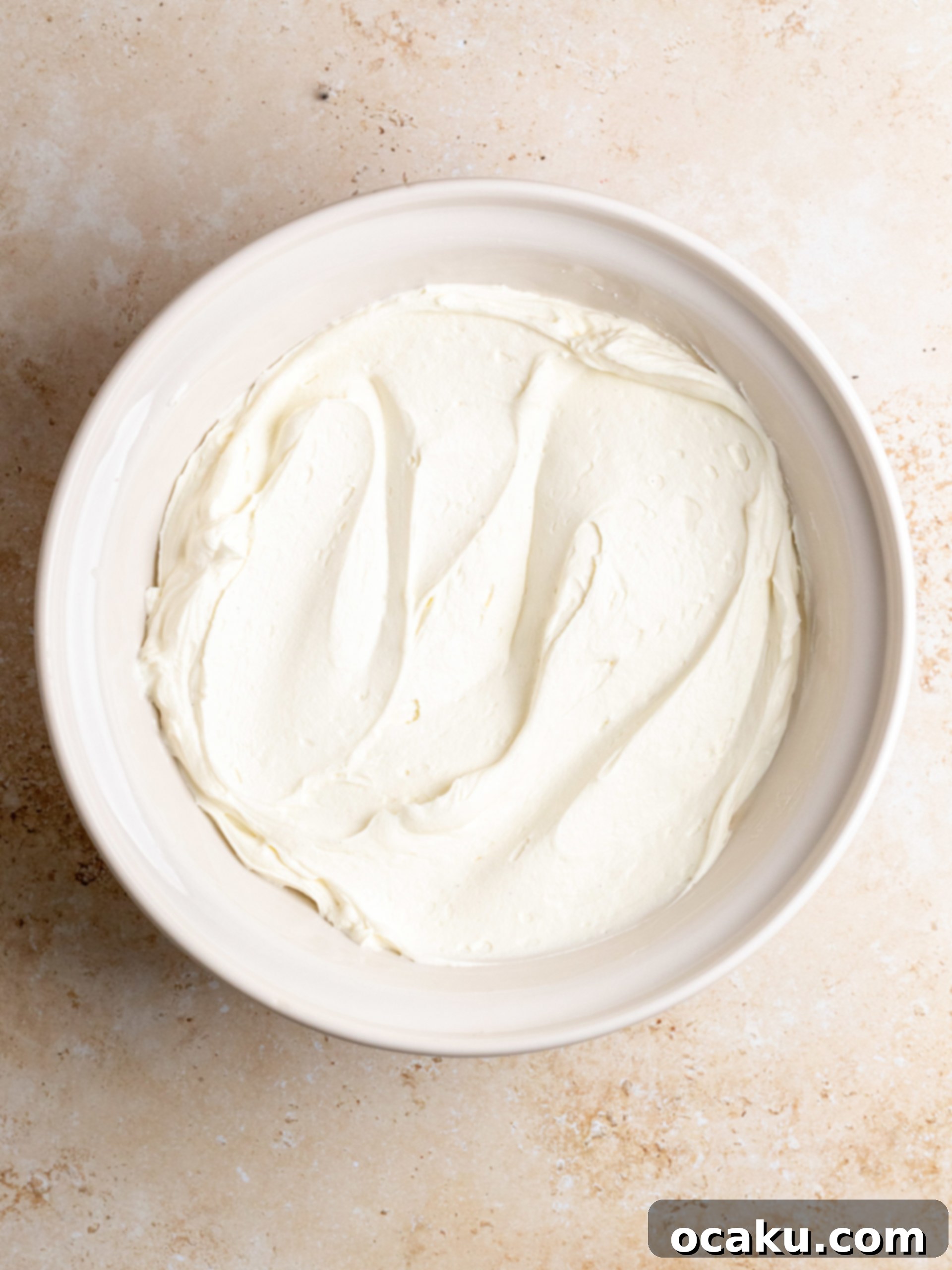 Raspberry Dream Tiramisu 5 Straining the raspberry syrup through a fine-mesh sieve into a bowl, separating the liquid from the pulp.