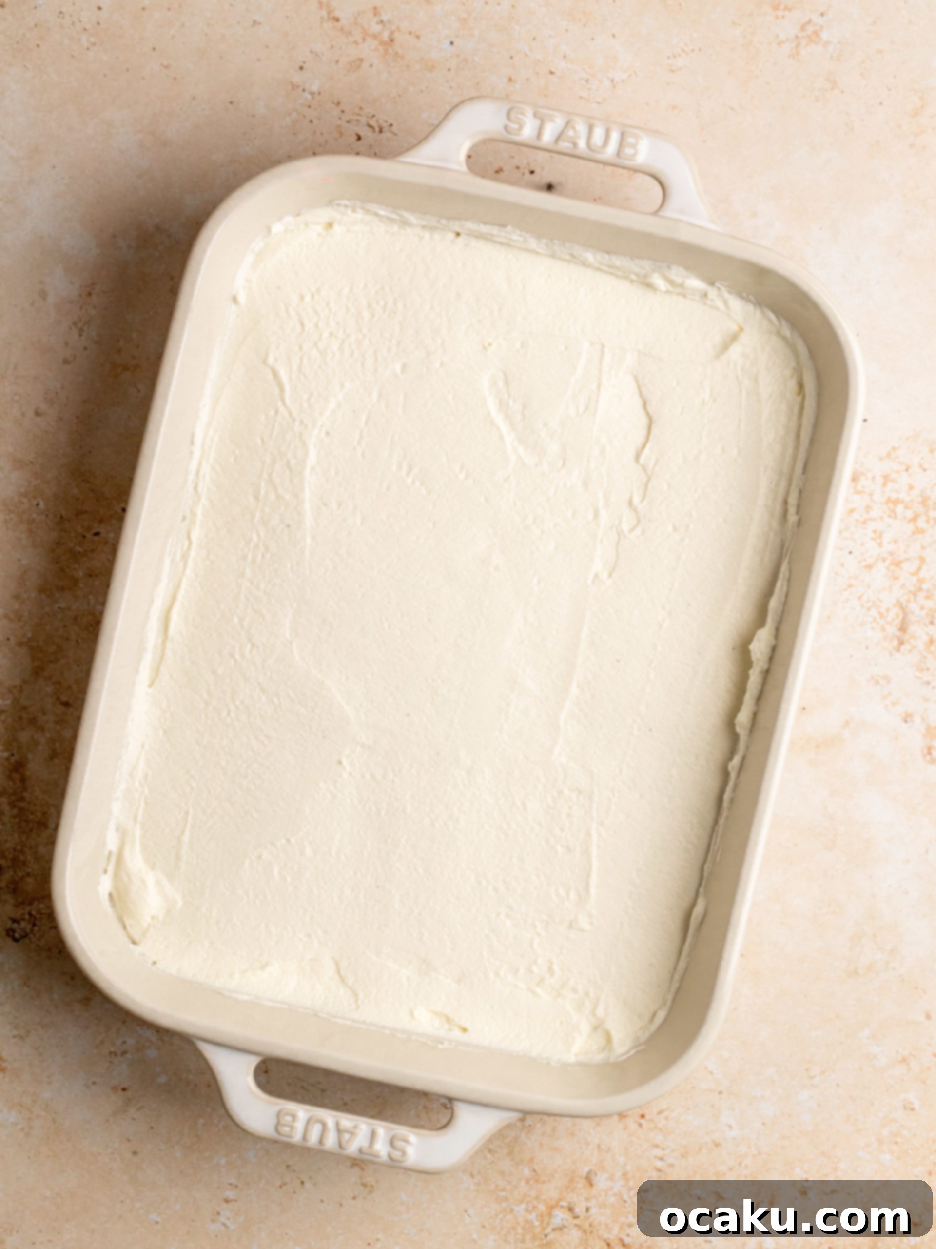 Raspberry Dream Tiramisu 7 Mixing cold mascarpone cheese, powdered sugar, lemon juice, and vanilla paste with an electric hand mixer.