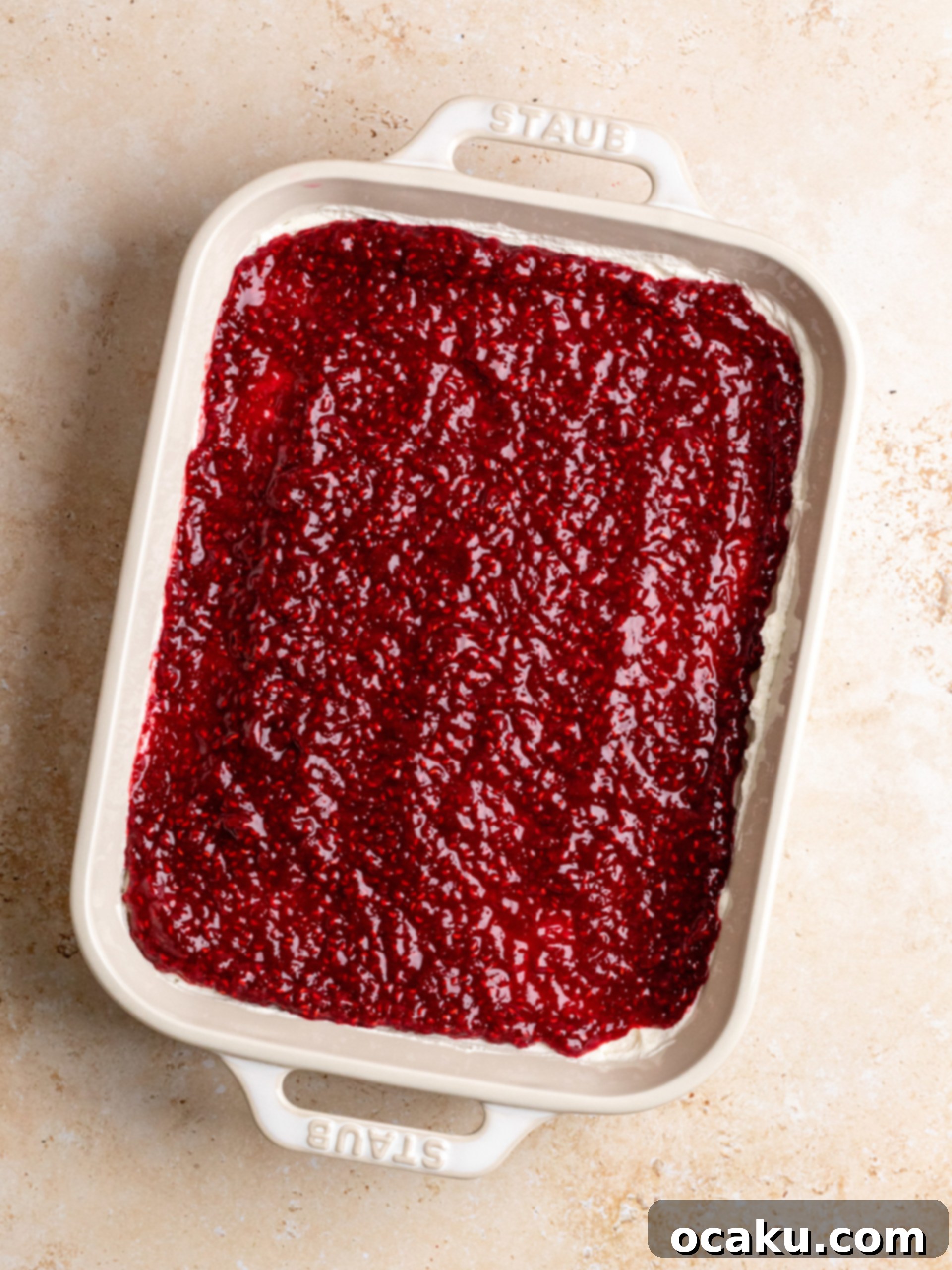 Raspberry Dream Tiramisu 8 Adding heavy cream to the mascarpone mixture and whisking it to a medium-stiff peak.