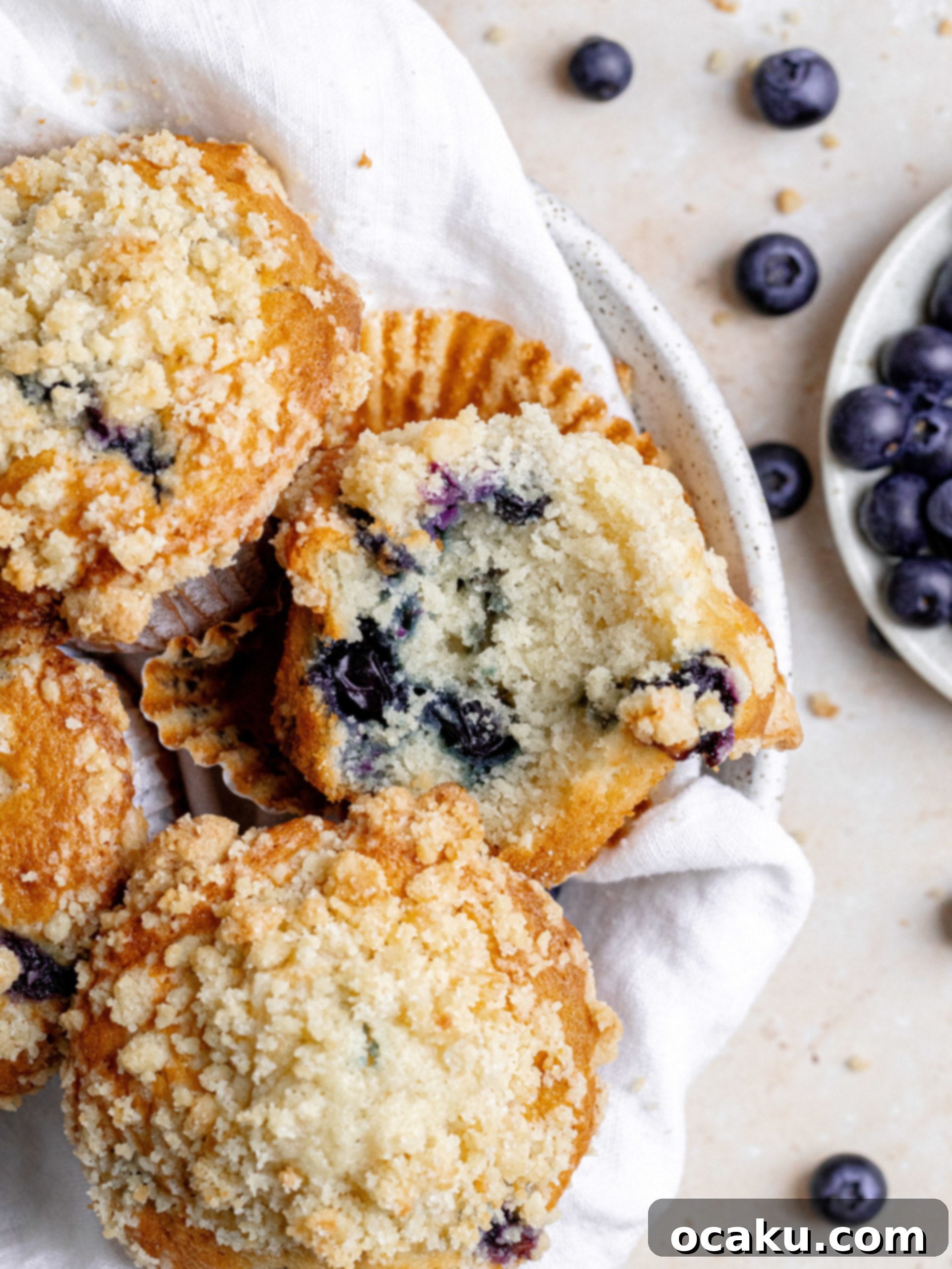 Tall Bakery Style Blueberry Muffins with a streusel crumb topping