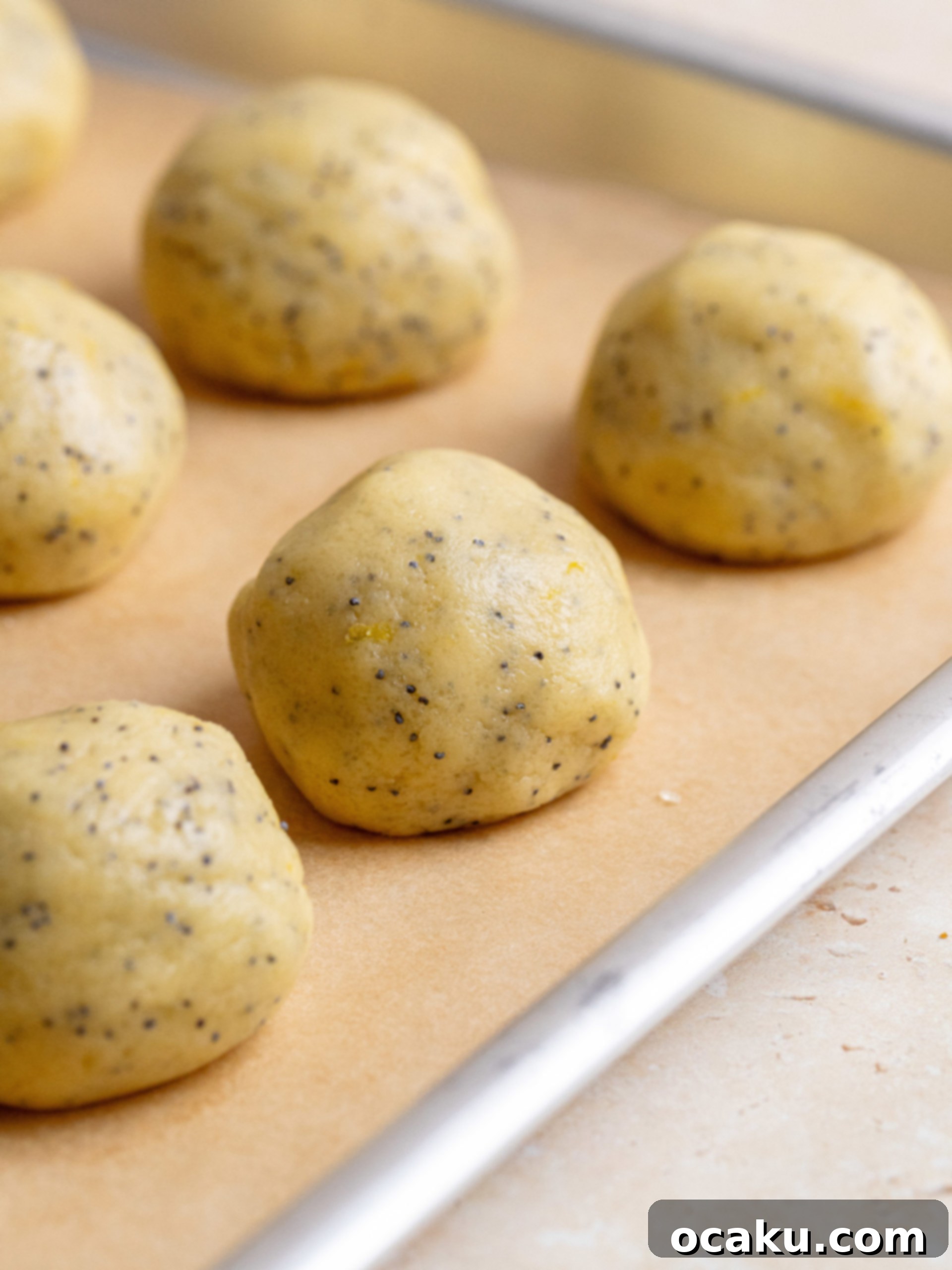 Wet ingredients being mixed in a bowl, with melted butter, lemon sugar, egg, and vanilla extract