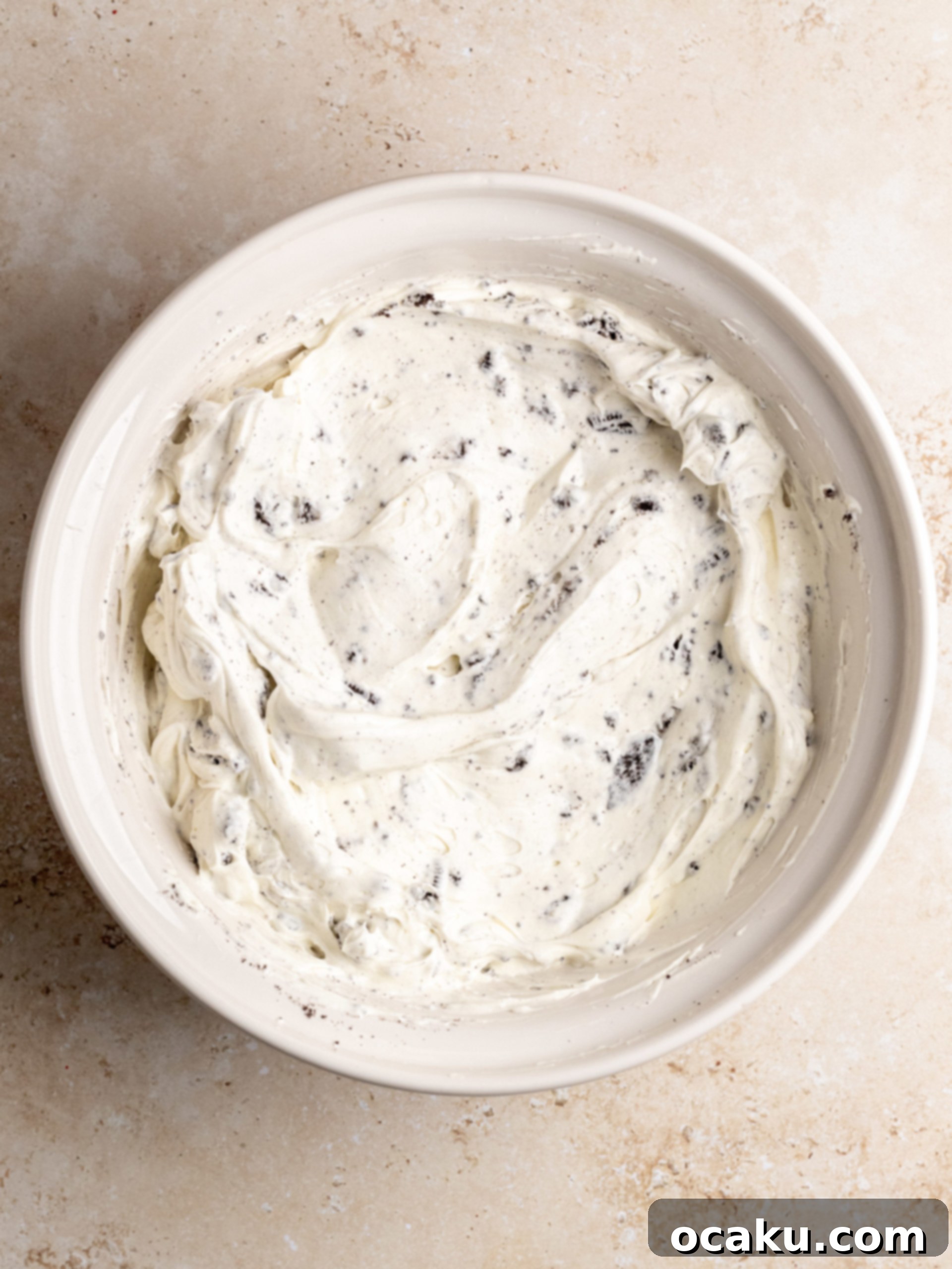 Easy No-Bake Oreo Cheesecake 5 Pouring chocolate ganache over the chilled No-Bake Oreo Cheesecake