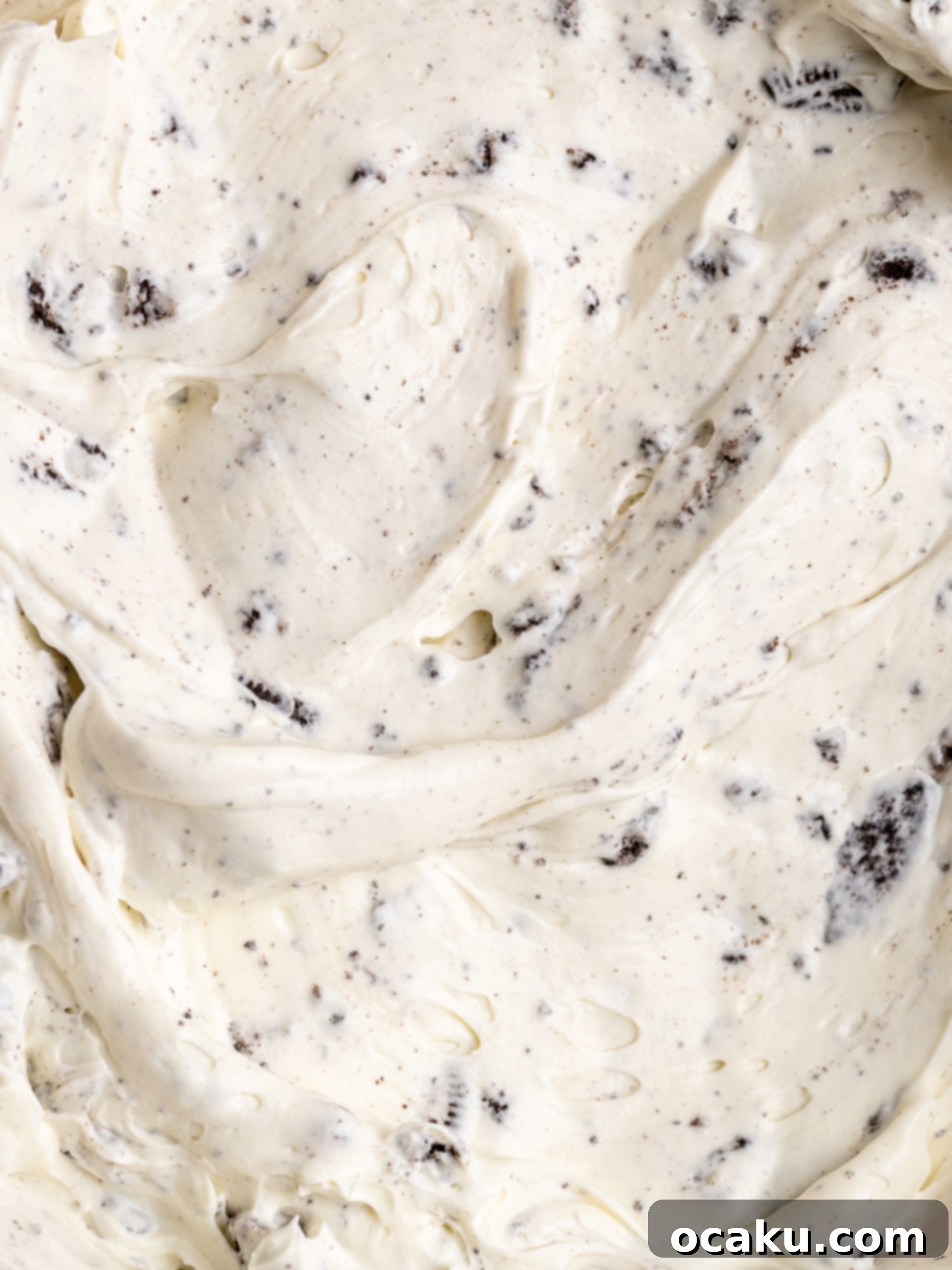 Easy No-Bake Oreo Cheesecake 6 Decorating the No-Bake Oreo Cheesecake with piped whipped cream and mini Oreos