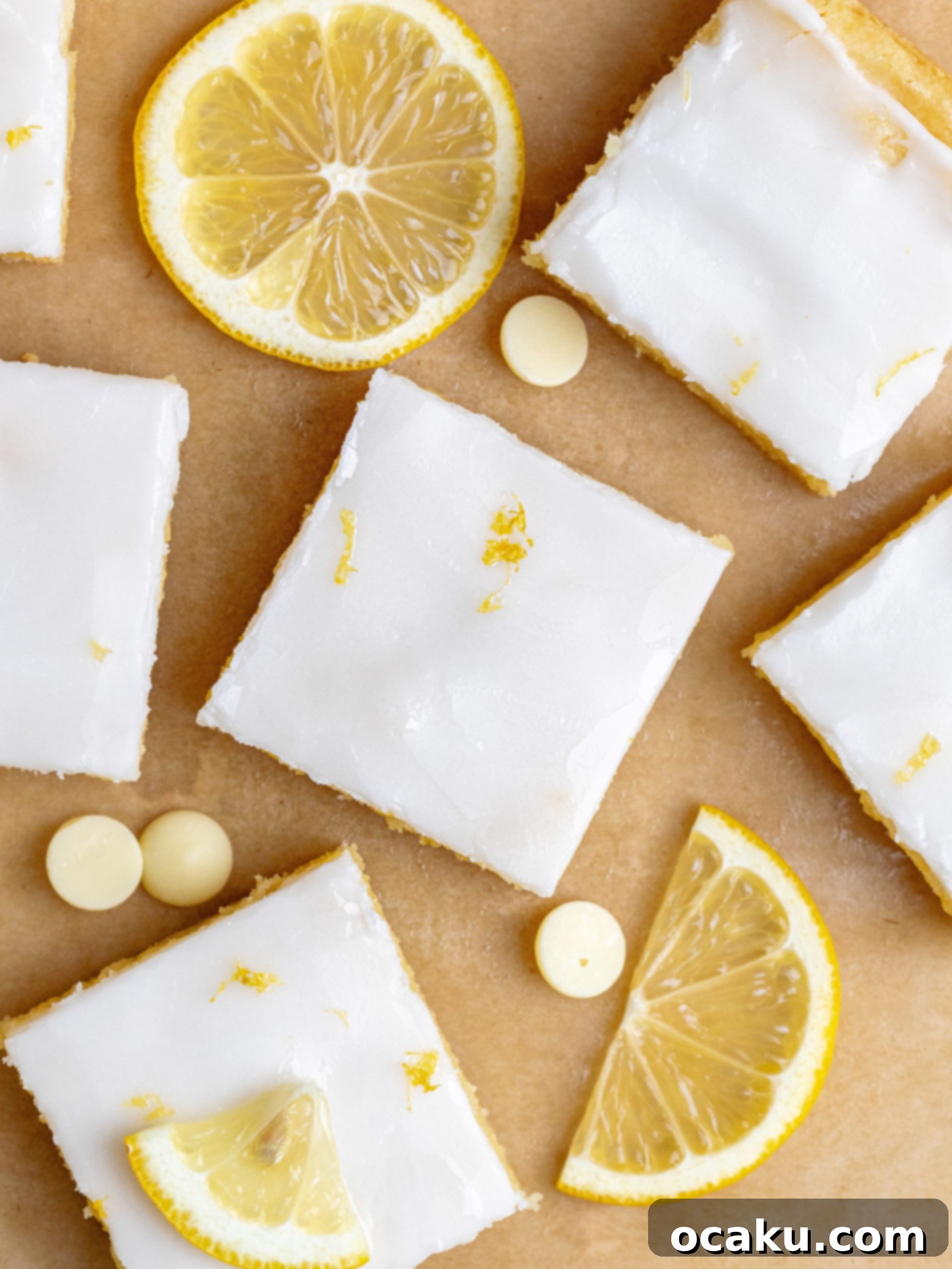 Zesty Lemon Fudge Squares 5 Sliced lemon brownies with white chocolate glaze and lemon zest on top, arranged on a serving plate.