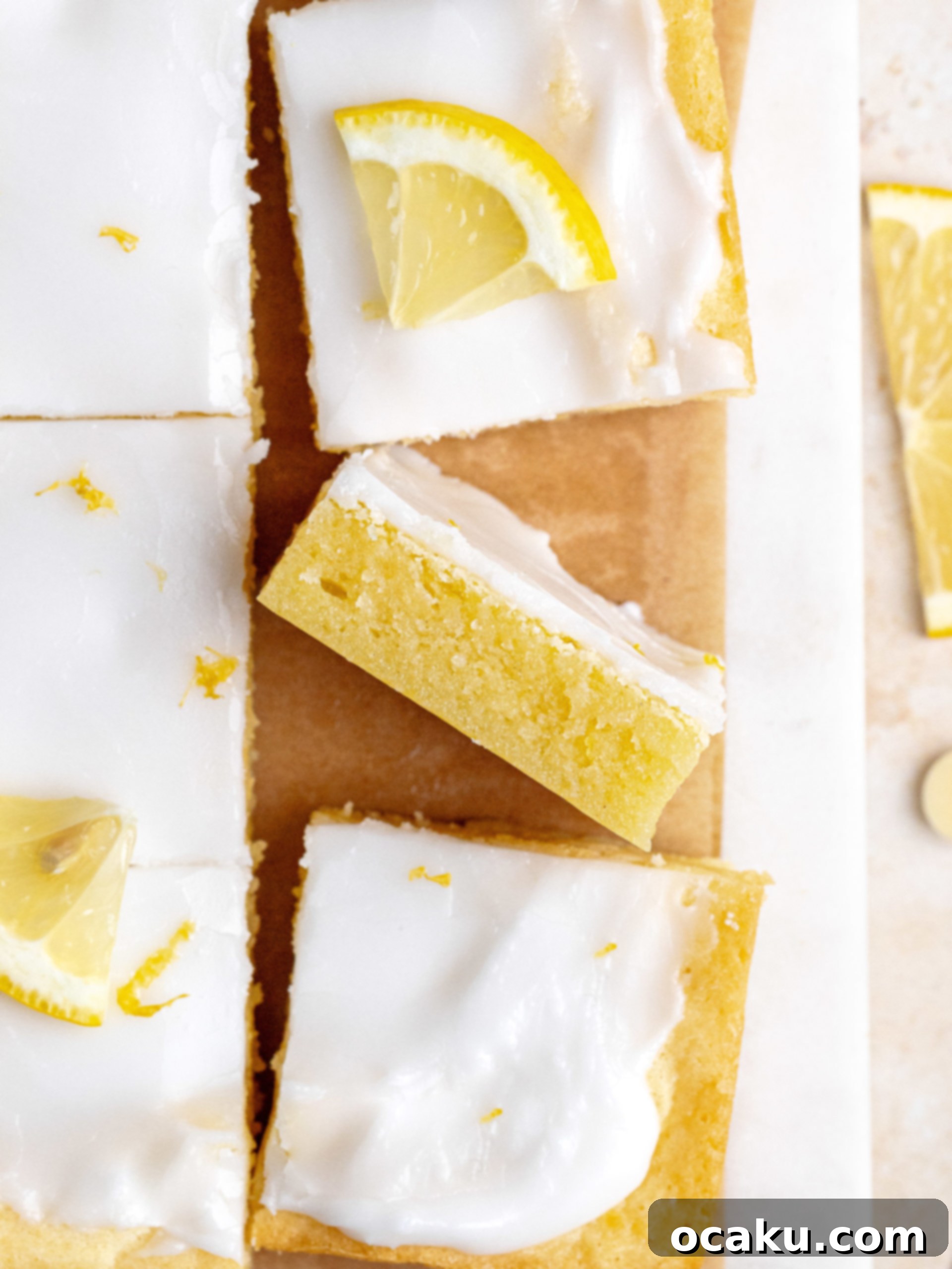 Zesty Lemon Fudge Squares 6 A stack of three lemon brownies on a small white plate, showing the fudgy texture and glaze.