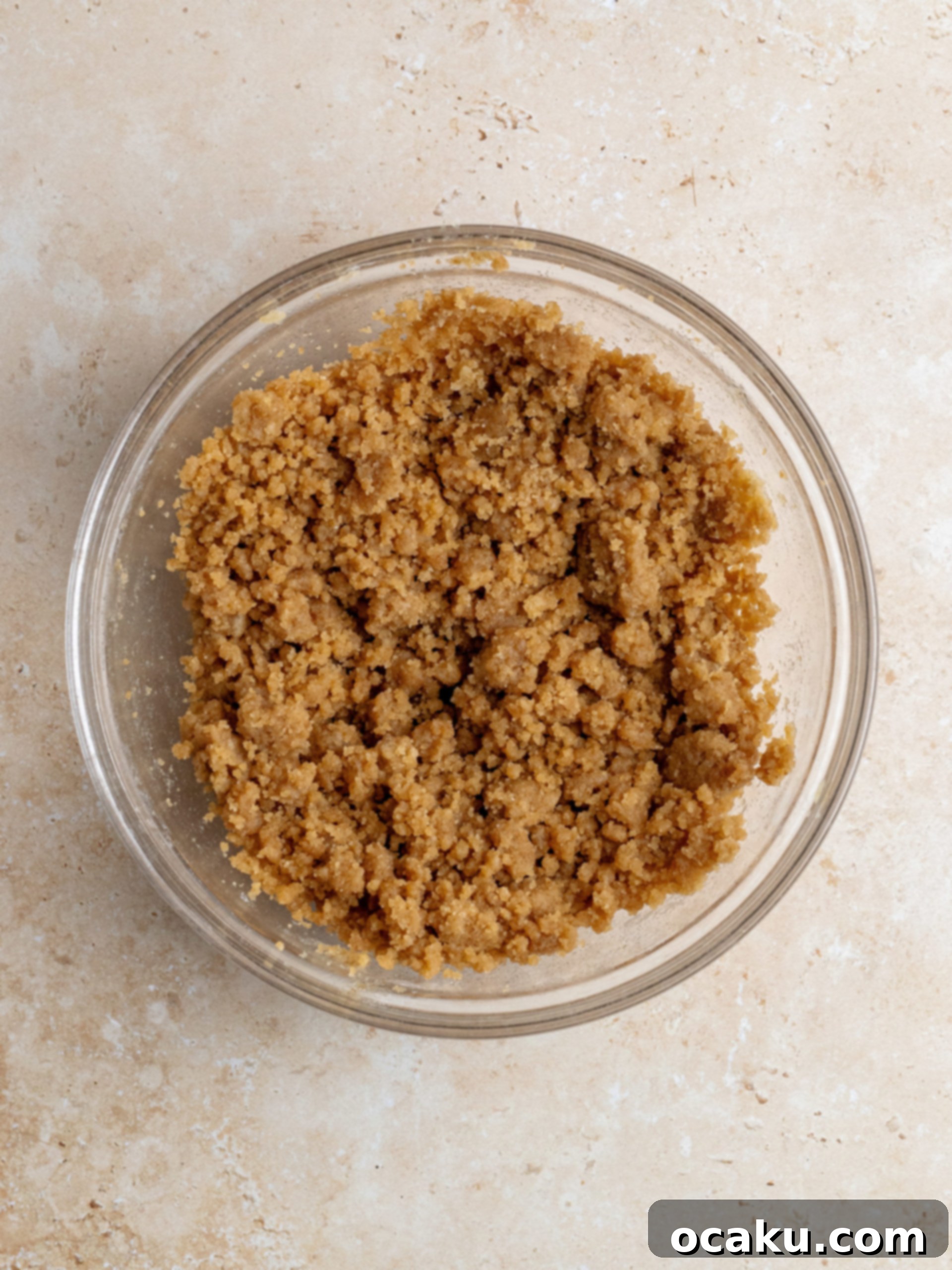 Cheesecake batter being poured into the prepared cookie crust.