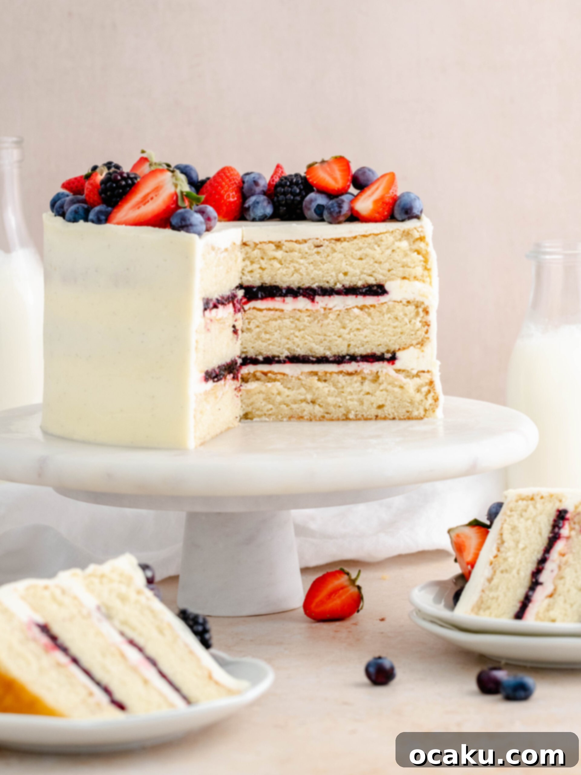 Strawberry and blueberry layer cake, a perfect summer dessert with almond cake and vanilla buttercream