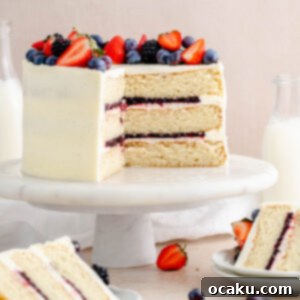 Strawberry and blueberry layer cake, a perfect summer dessert with almond cake and vanilla buttercream