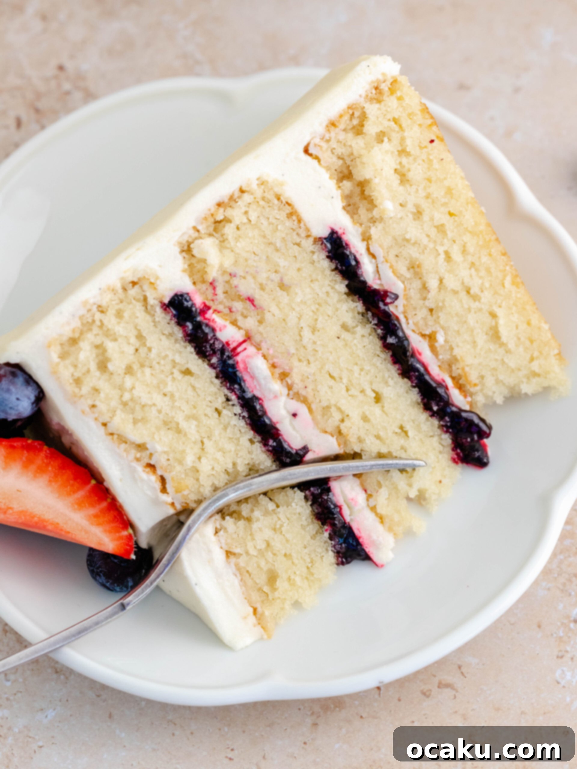 Fully decorated strawberry and blueberry layer cake with fresh berries on top