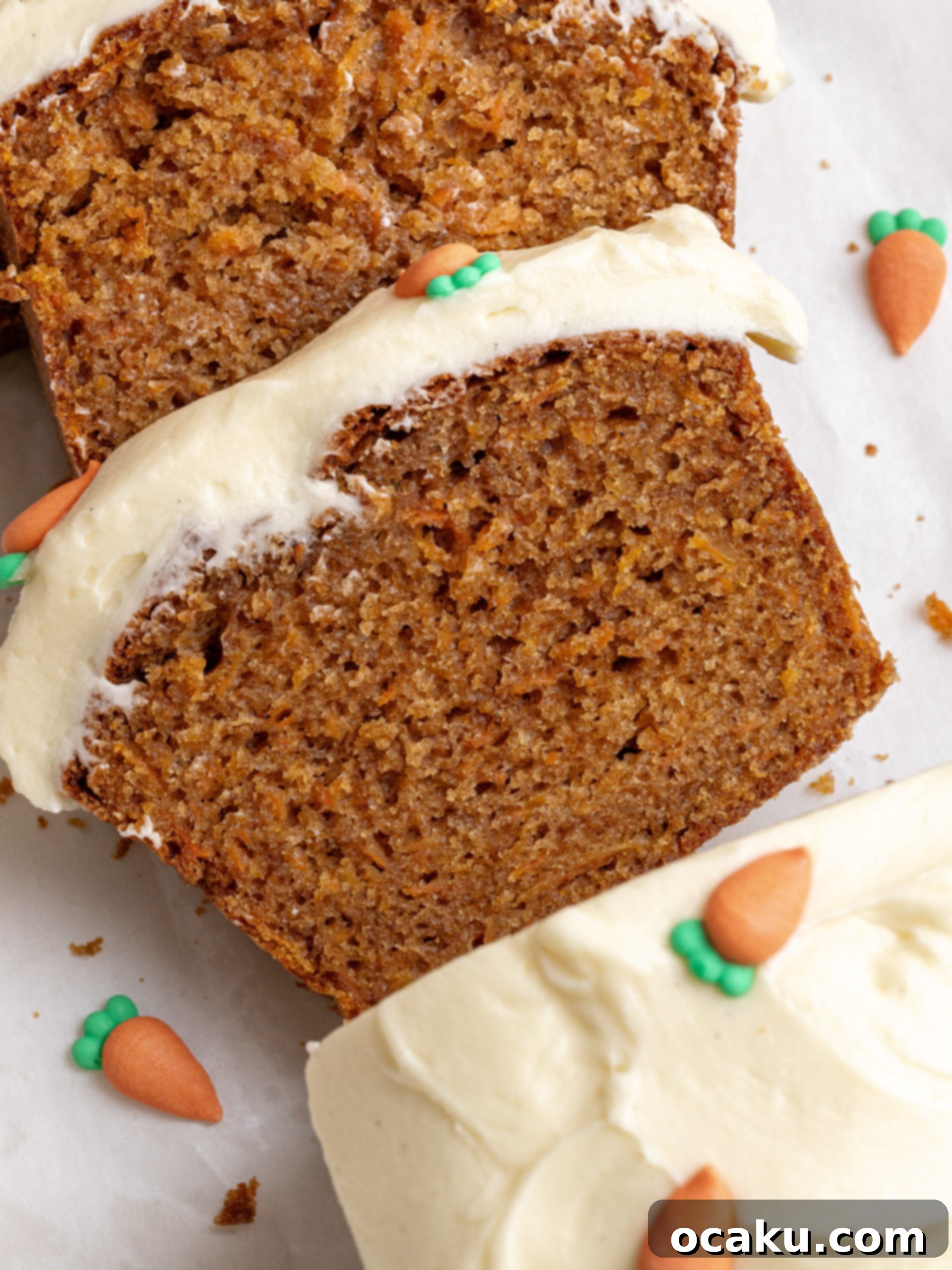 Spiced Carrot Loaf 2 A perfectly baked and frosted carrot cake loaf cake on a cooling rack, showcasing its moist texture and rich cream cheese topping.