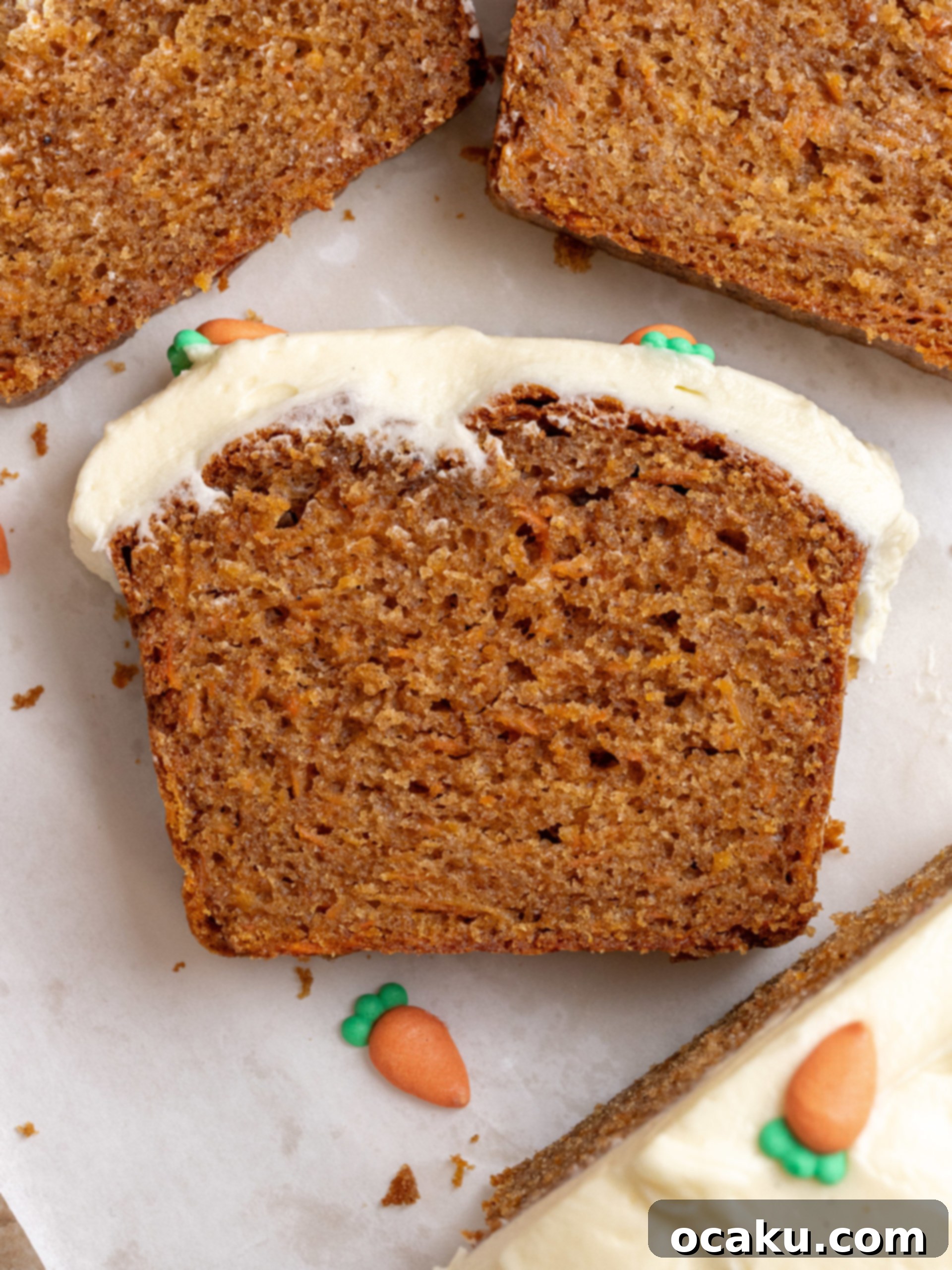 Spiced Carrot Loaf 8 A slice of carrot cake loaf with cream cheese frosting, ready to be served.