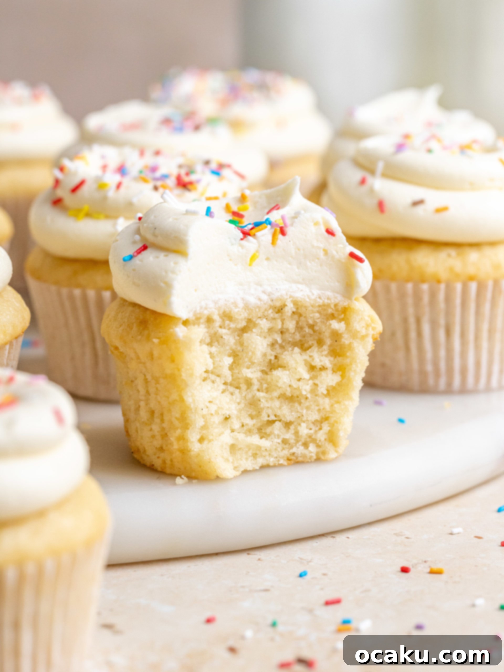 Delicious Vanilla Birthday Cupcakes with smooth vanilla buttercream and sprinkles, ready for a celebration.