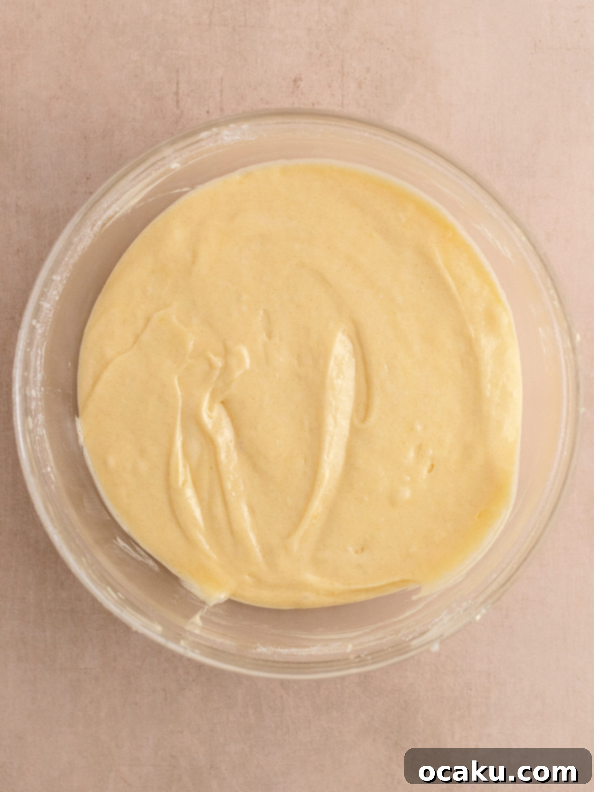 Step-by-step image showing mixed cupcake batter in a bowl.