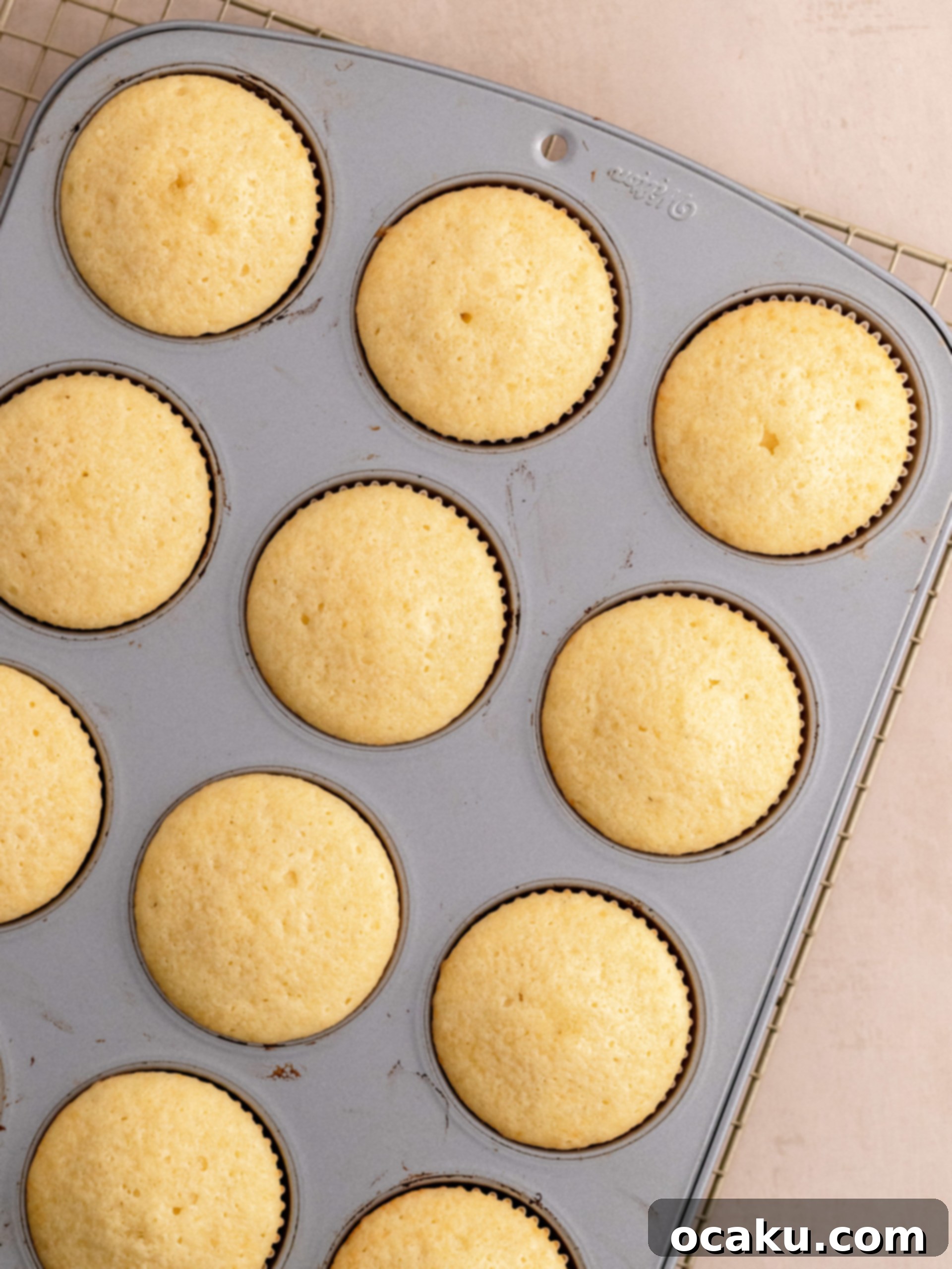 Step-by-step image showing buttercream being piped onto a vanilla cupcake.