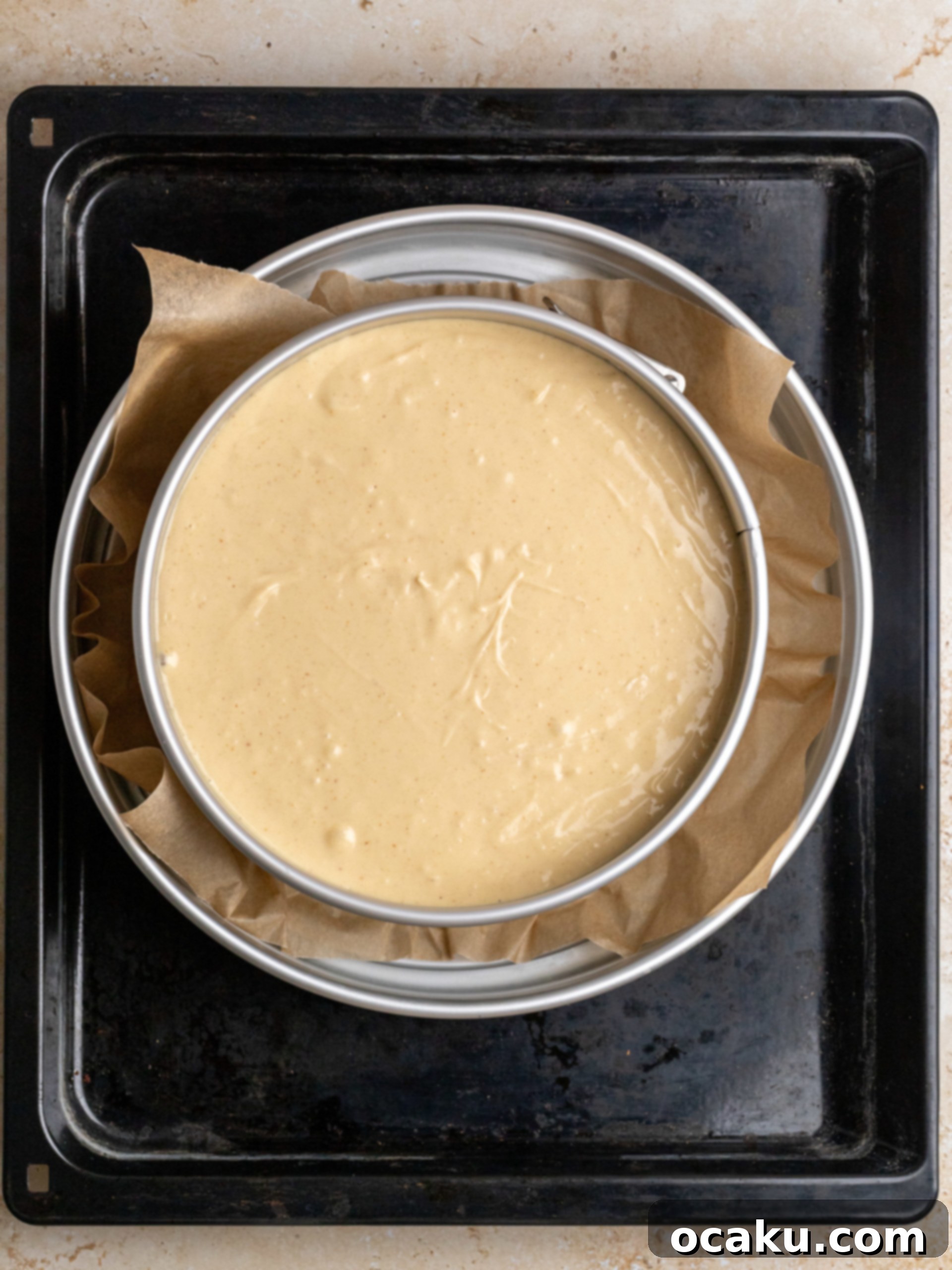 The baked cheesecake, golden brown around the edges and still slightly wobbly in the center, cooling in the oven.