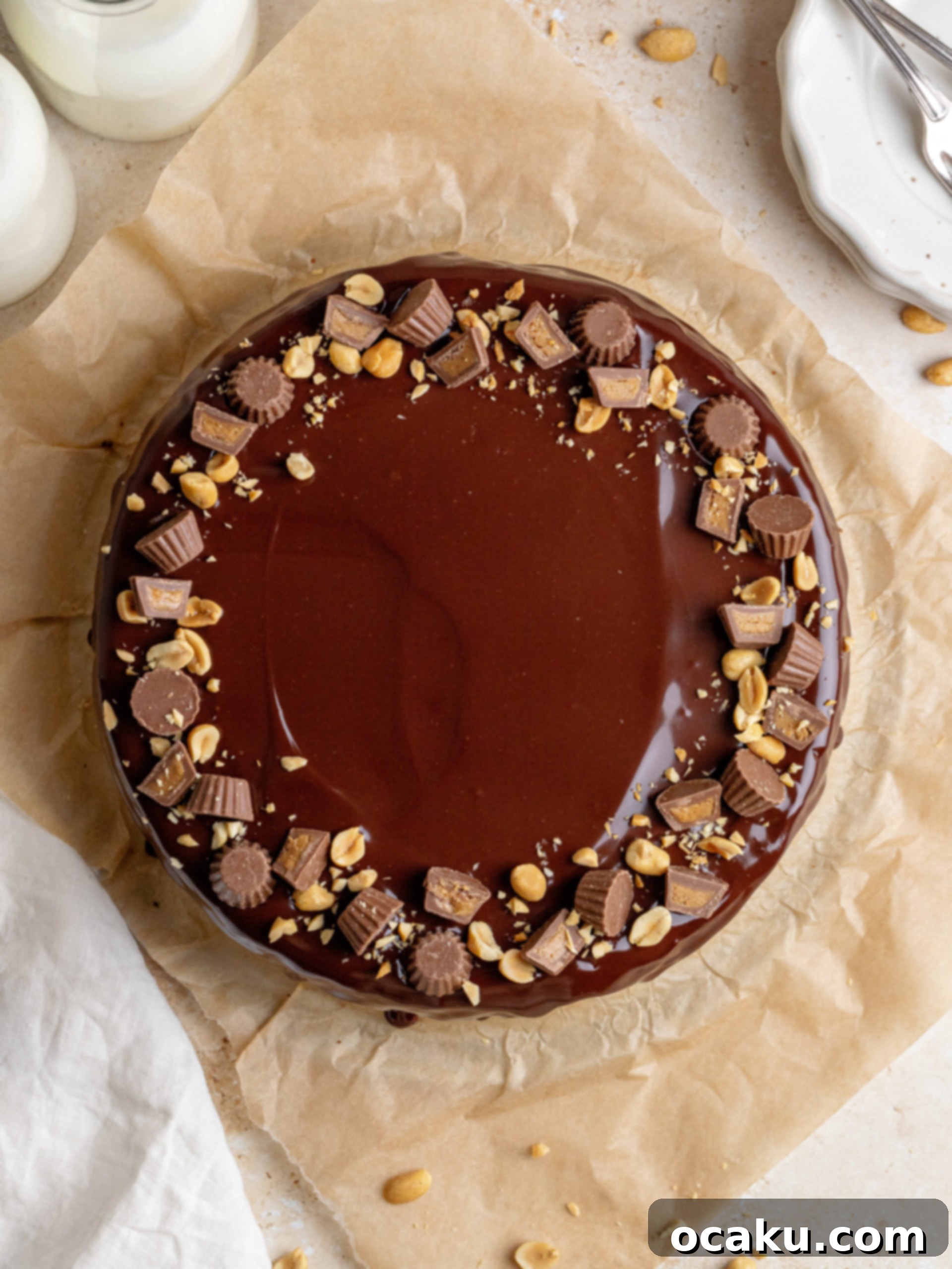 The finished Peanut Butter Chocolate Cheesecake, beautifully decorated with mini Reese's cups and chopped peanuts.