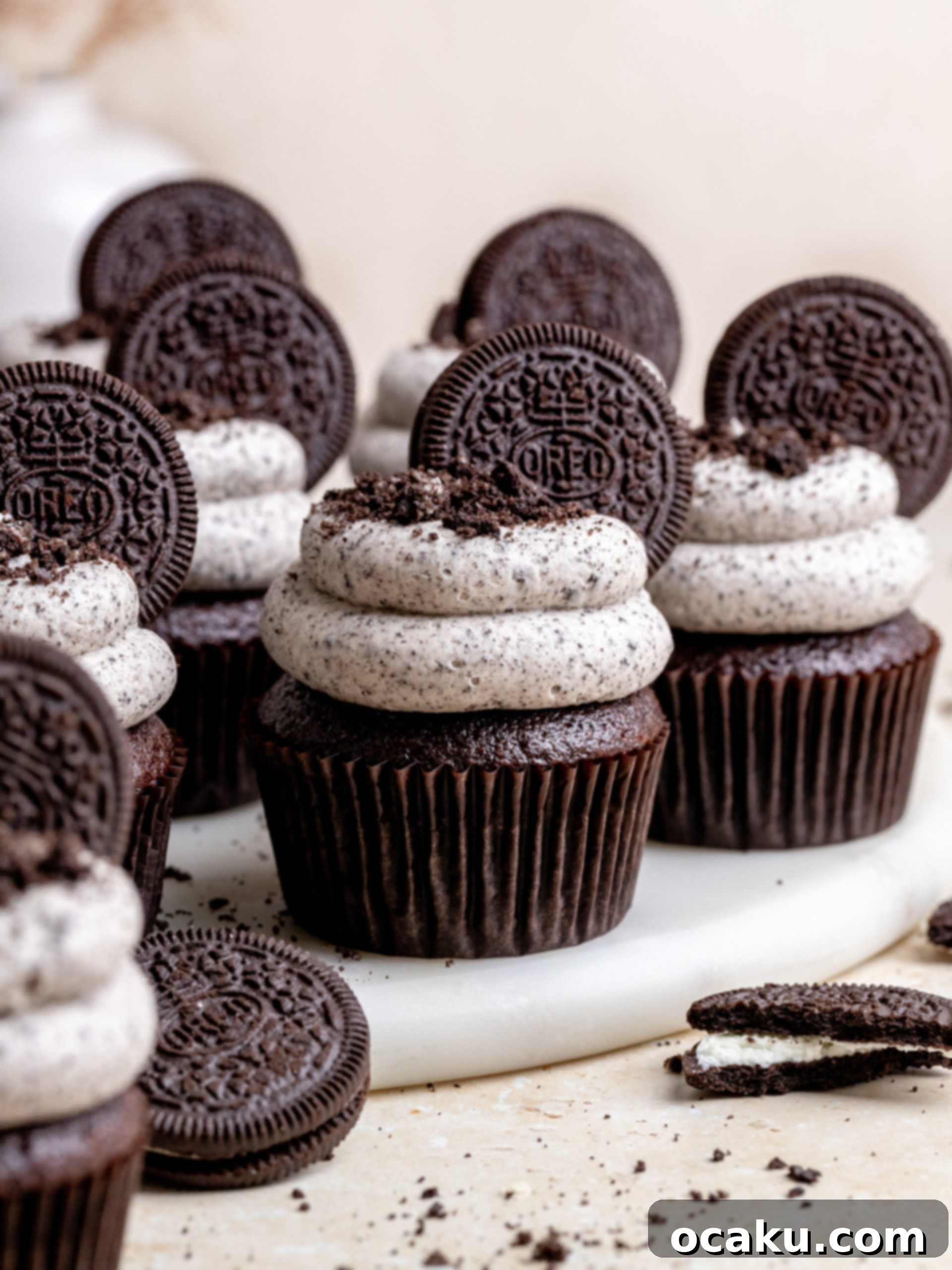 Close-up of an Oreo cupcake showing the generous swirl of Oreo buttercream and crushed cookie pieces, indicating its rich texture and flavor.