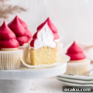 A stunning Raspberry Cream Puff Cupcake with a glossy finish.