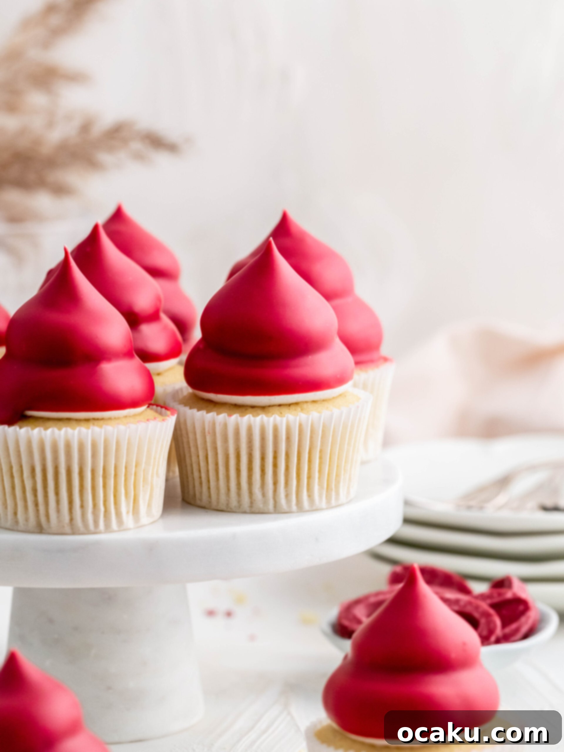 Raspberry Cream Puff Cupcakes displayed on a elegant cake stand.