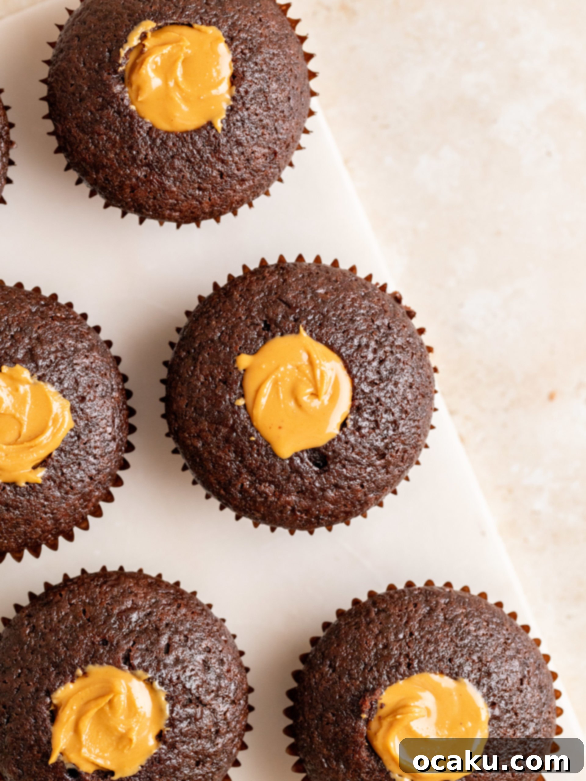 Coring out the center of a chocolate cupcake for filling.